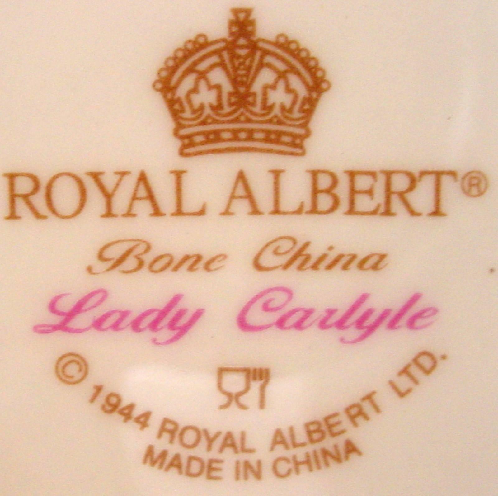 ROYAL ALBERT china LADY CARLYLE pattern TEAPOT with Lid 

in great condition free from chips, cracks, break, stain, or discoloration and with only a minimum of use. 

• Production dates 1980 -. 

• Measures @ 48 oz.

• Pink Floral.

• Gold