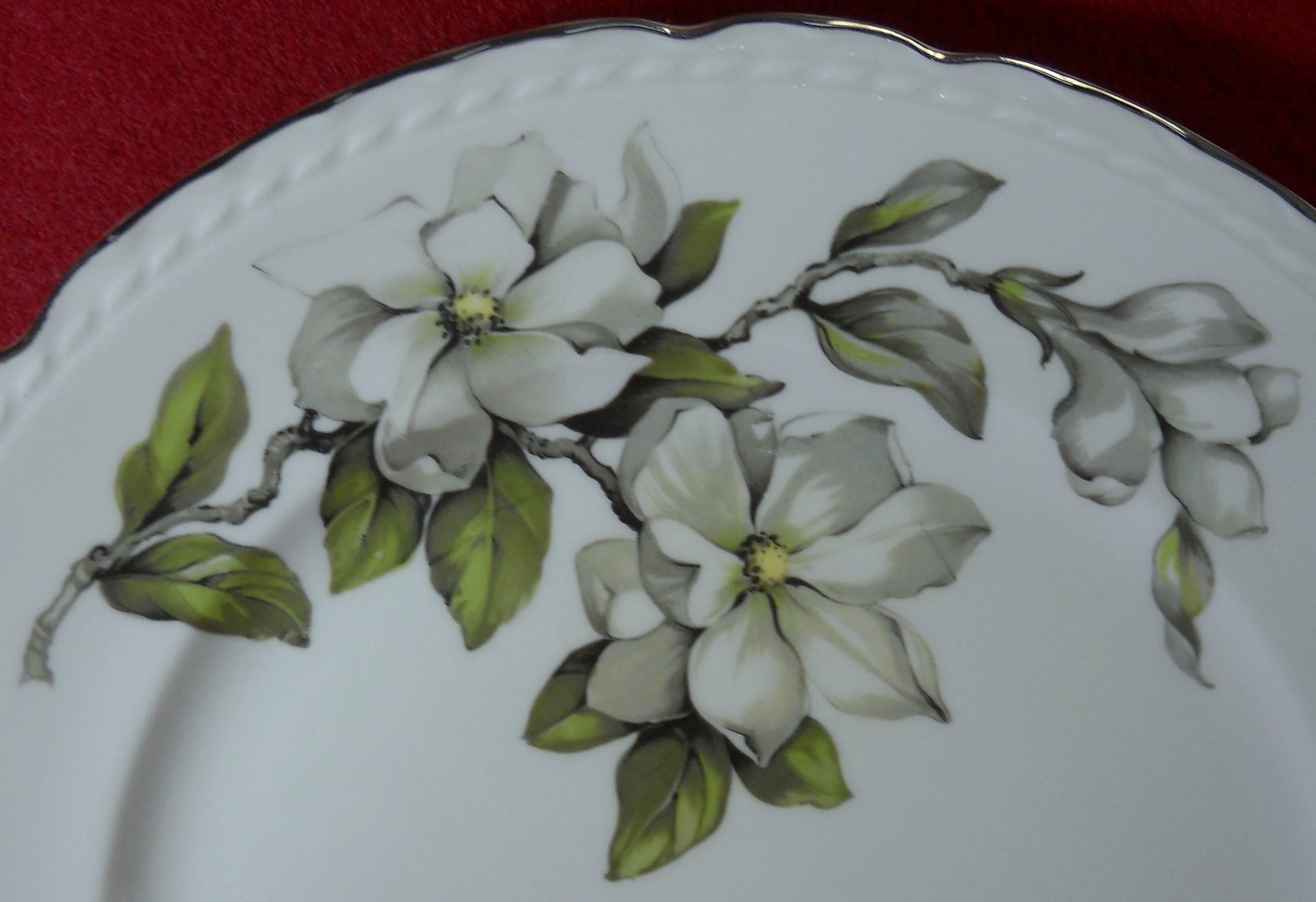 Embassy (American) china Silver Gardenia pattern 53-piece set service for eight 

in great condition free from chips, cracks, breaks or stains. Some items show minor wear.

White flowers with embossed rim. 

Includes eight cups, eight