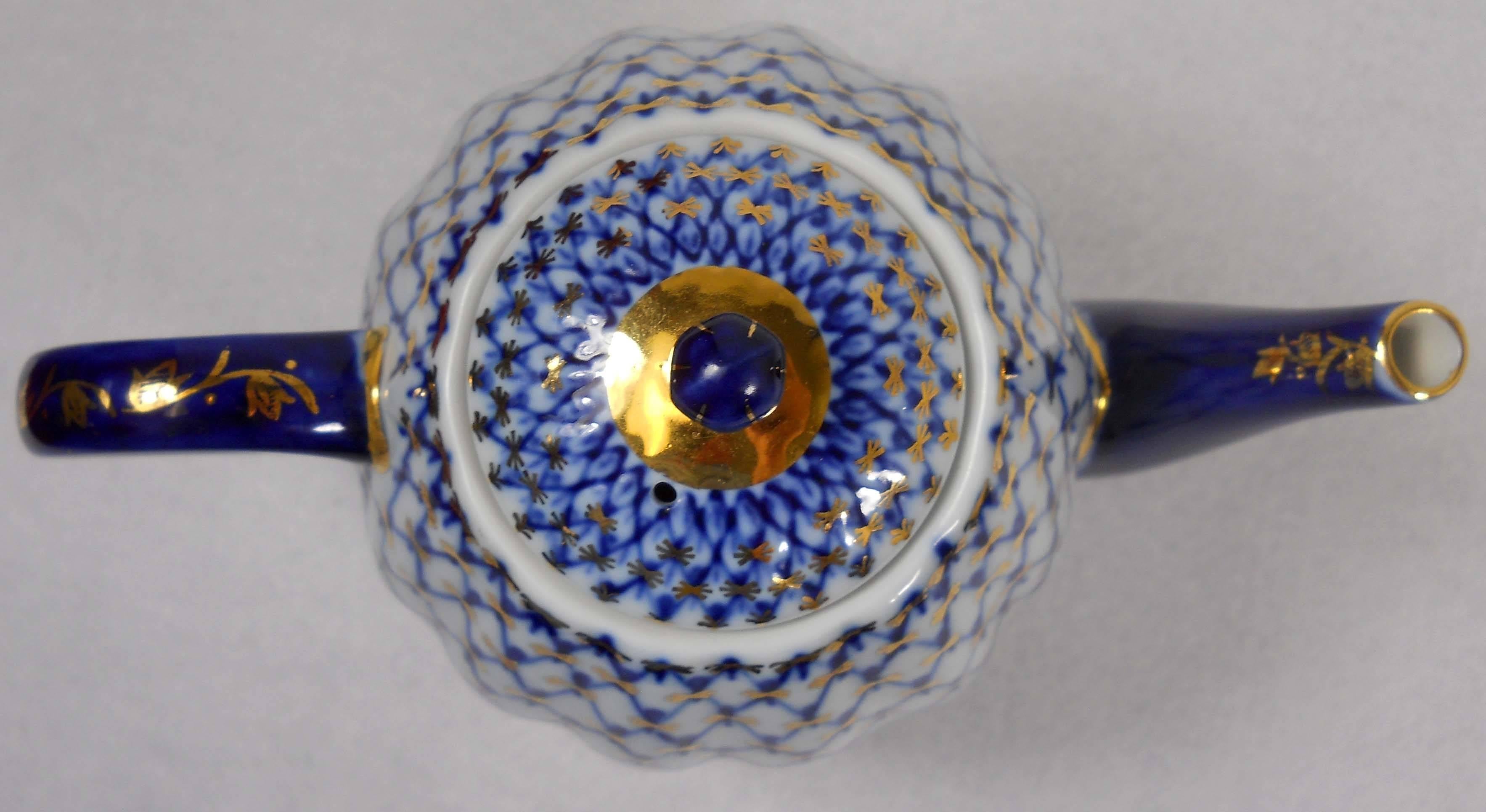 Beautifully hand painted cobalt blue “net” design embellished with at 18-karat gold. This Coffee pot was made in the imperial Russian porcelain factory in St. Petersburg. The coffee pot measures 6-1/8 inches table to spout, and 5 inches at the