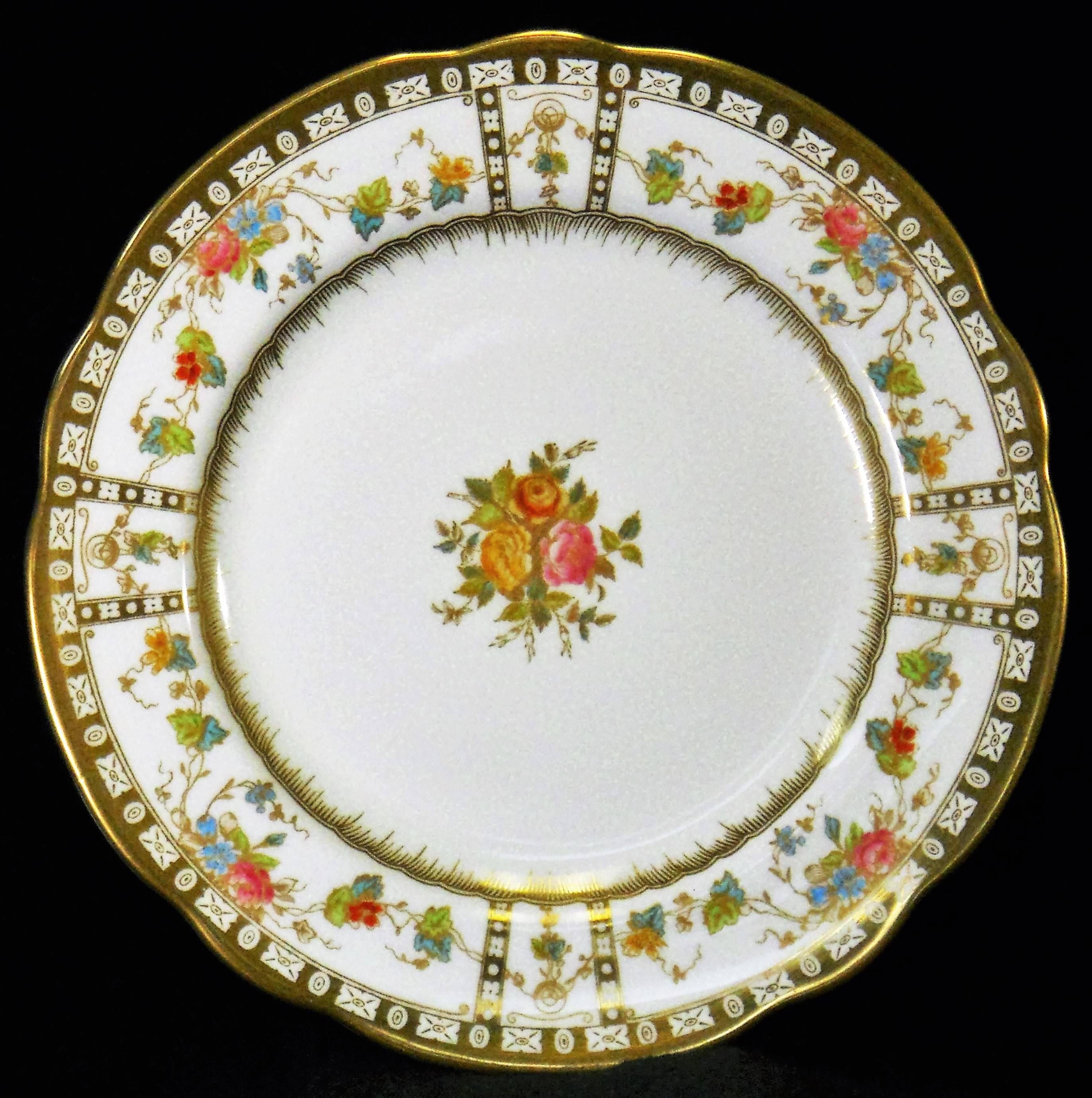 This beautiful Set of Ten plates have a wonderful thick gold boarder with geometric shapes and columns. As well as, intricate gold leaves and swags around the rim, and gold fluting around the verge. The Roses and other flowers have been hand