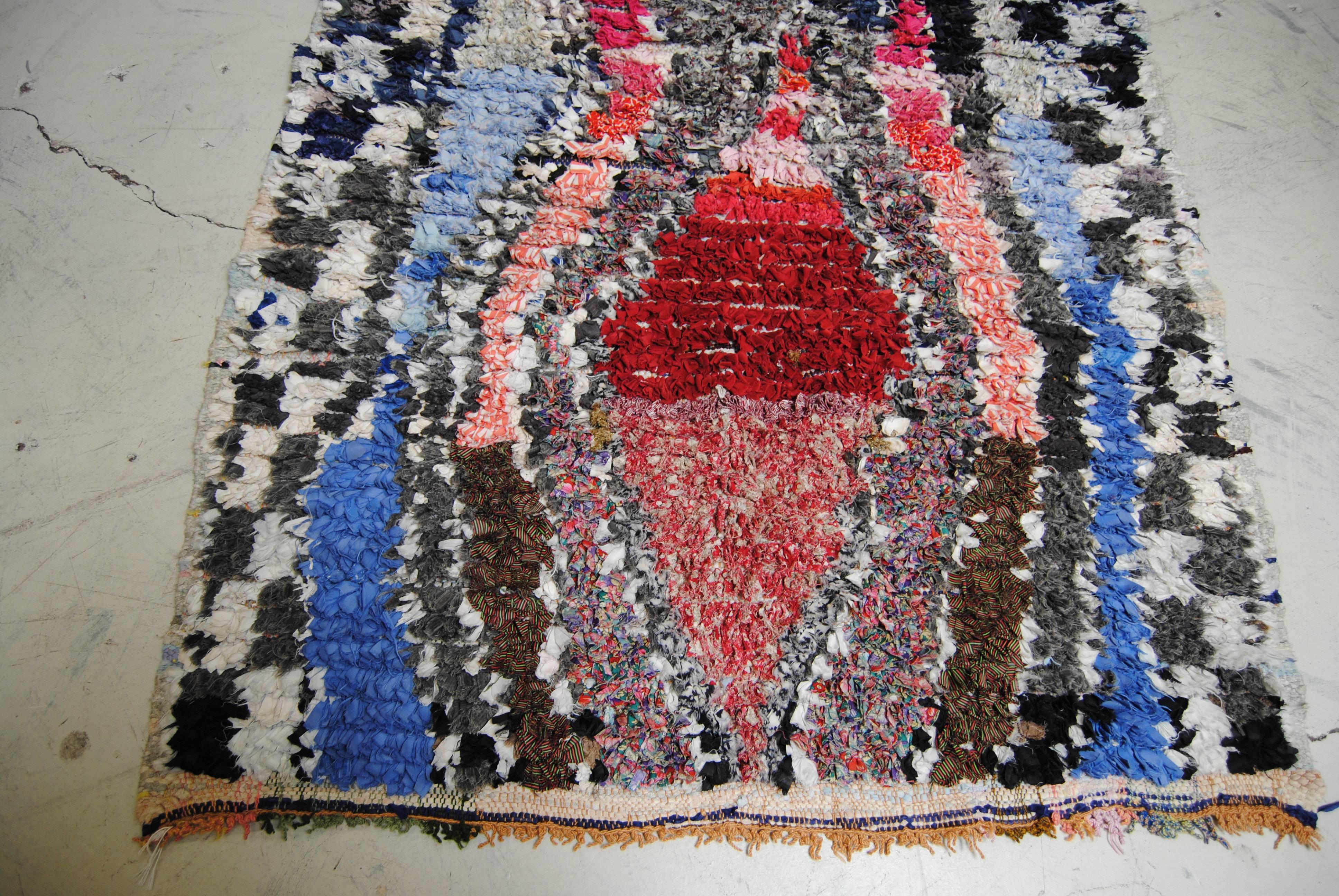 Moroccan boucherouite vintage rug made in the Atlas Mountains. This heavy hand loomed rug is made from cotton and assorted recycled textiles by the Berber tribes. Vibrant color is common in the boucherouite rug. Recently professionally cleaned, for