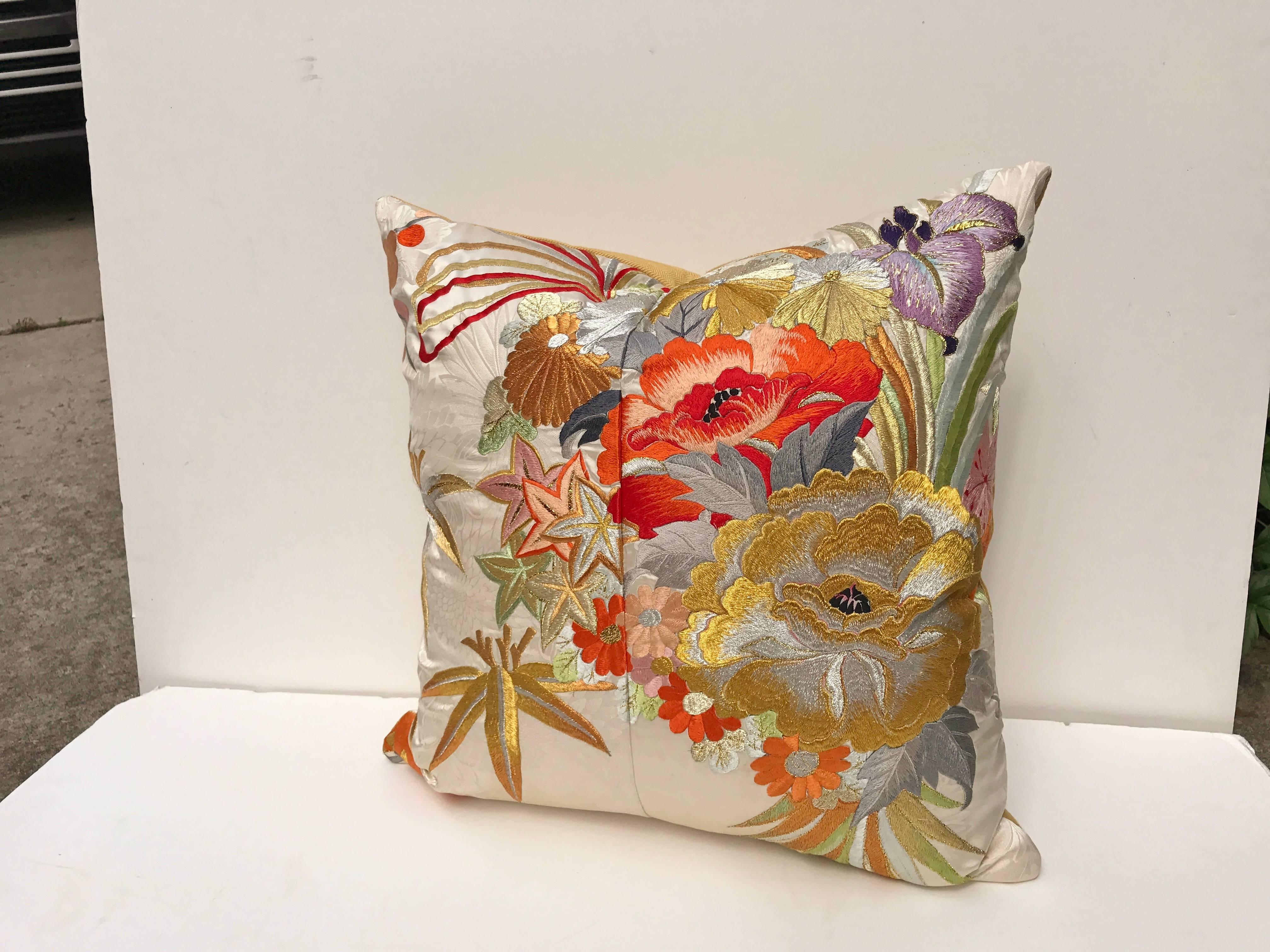 Custom pillow cut from a vintage Japanese silk uchikake, the traditional wedding kimono. The ivory silk is embroidered with vibrant silk and metallic threads. Pillow is backed in a soft gold silk, filled with an insert of 50/50 down and feathers and