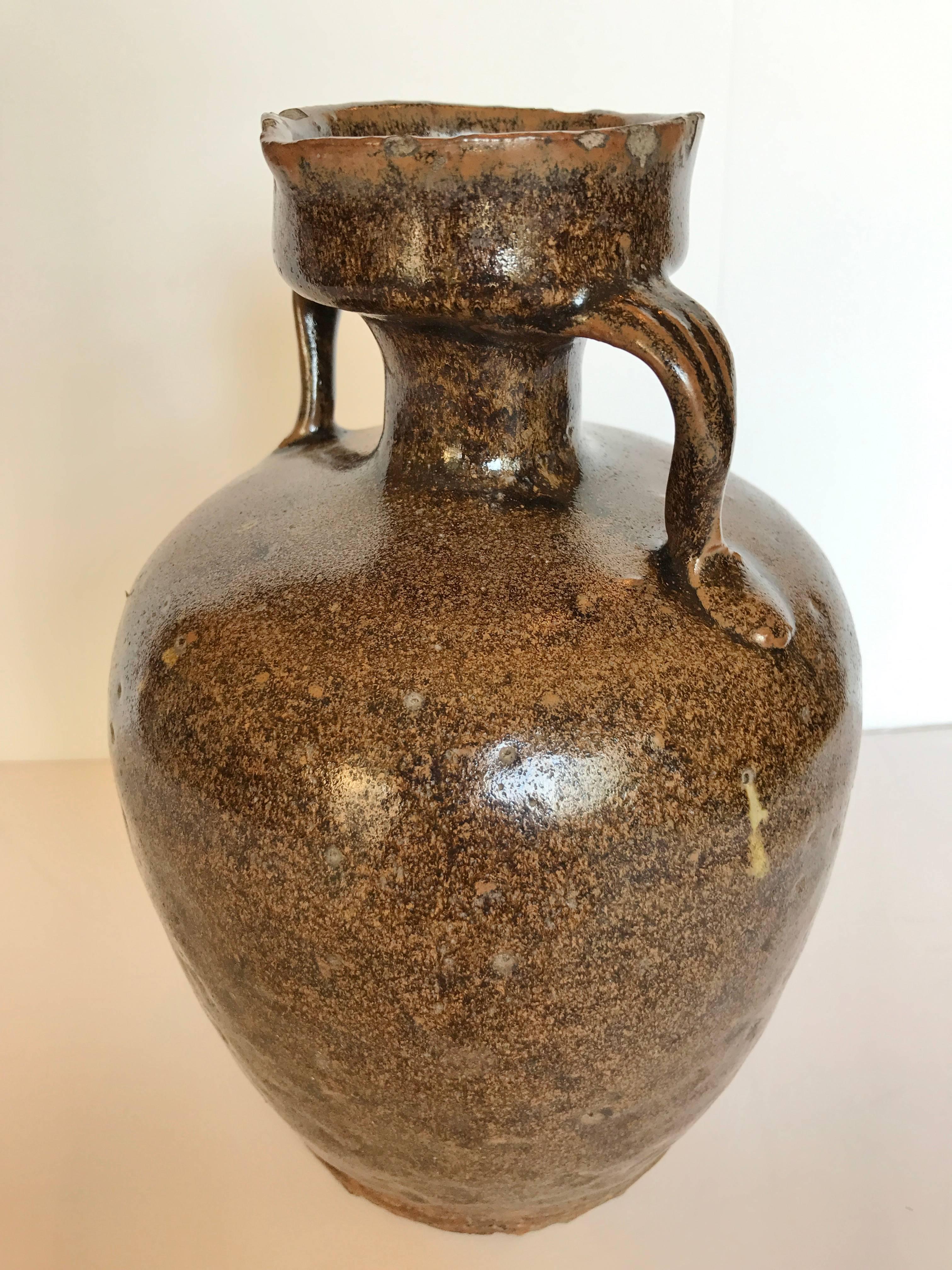Antique Chinese pottery wine glaze with beautiful glaze. Minimal flaking around spout but considering it'age it is in very good condition. It would have been used to store wine for Chinese household.