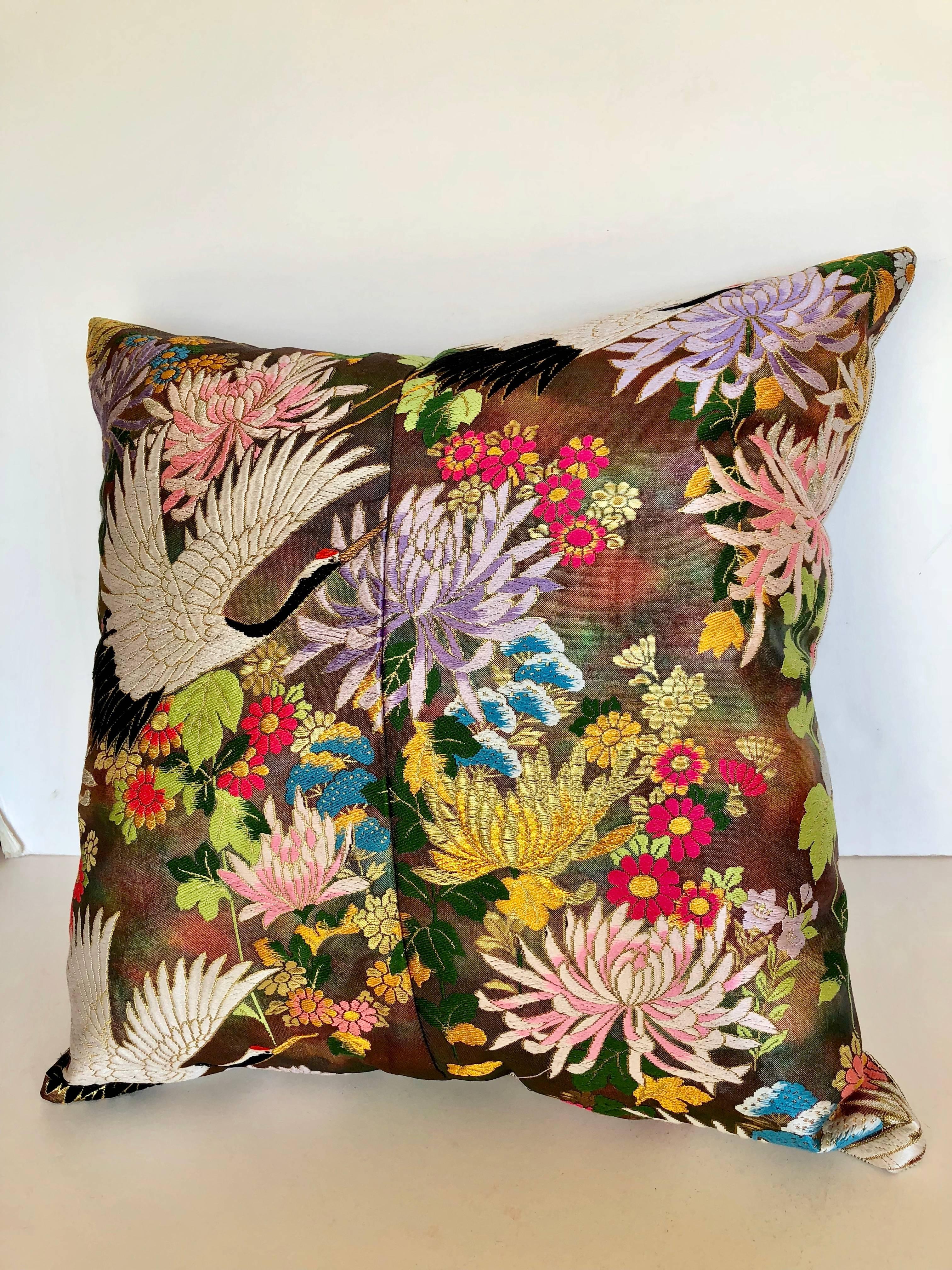 Custom pillow cut from a vintage Japanese silk Uchikake, the traditional wedding kimono. The silk textile is woven with vibrant floral and embroidered birds. The pillow is backed in a silk stripe, filled with an insert of 50/50 down and feathers and
