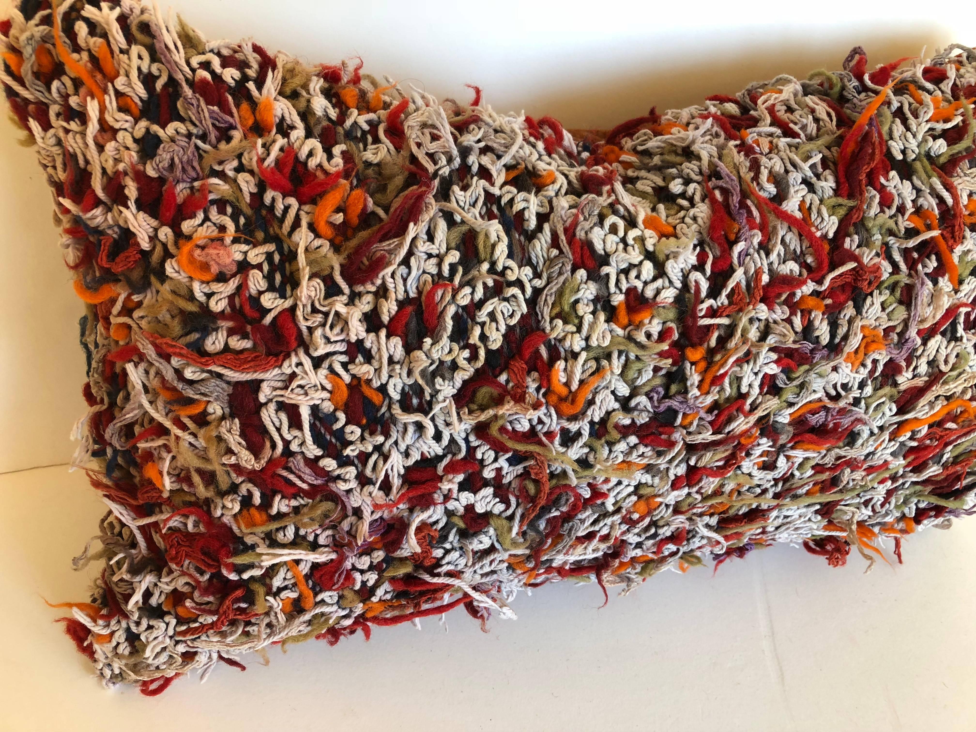 Custom pillow cut from a hand-loomed wool vintage Moroccan Berber rug from the Atlas mountains. This pillow is made from the reverse side of the rug where all the wool as left uncut after the weaving process. The pillow is backed in a deep paprika