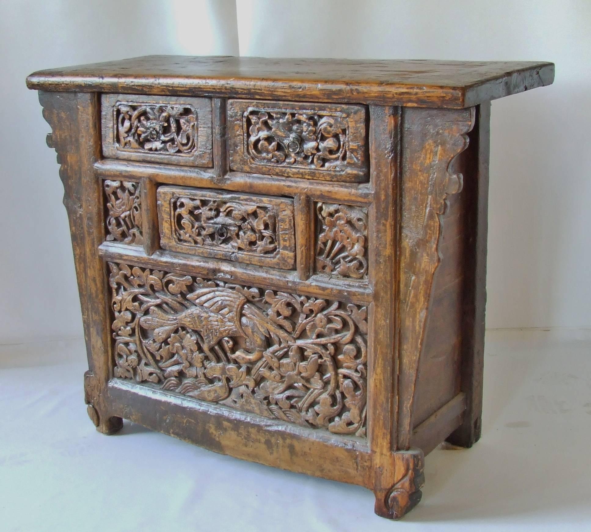 Outstanding hand-carved elmwood antique Chinese coffer. Cabinet has original lacquer finish with very deep carving. There are three drawers with an open space under the bottom drawer to hide your silver. The is a one of a kind piece of Chinese art