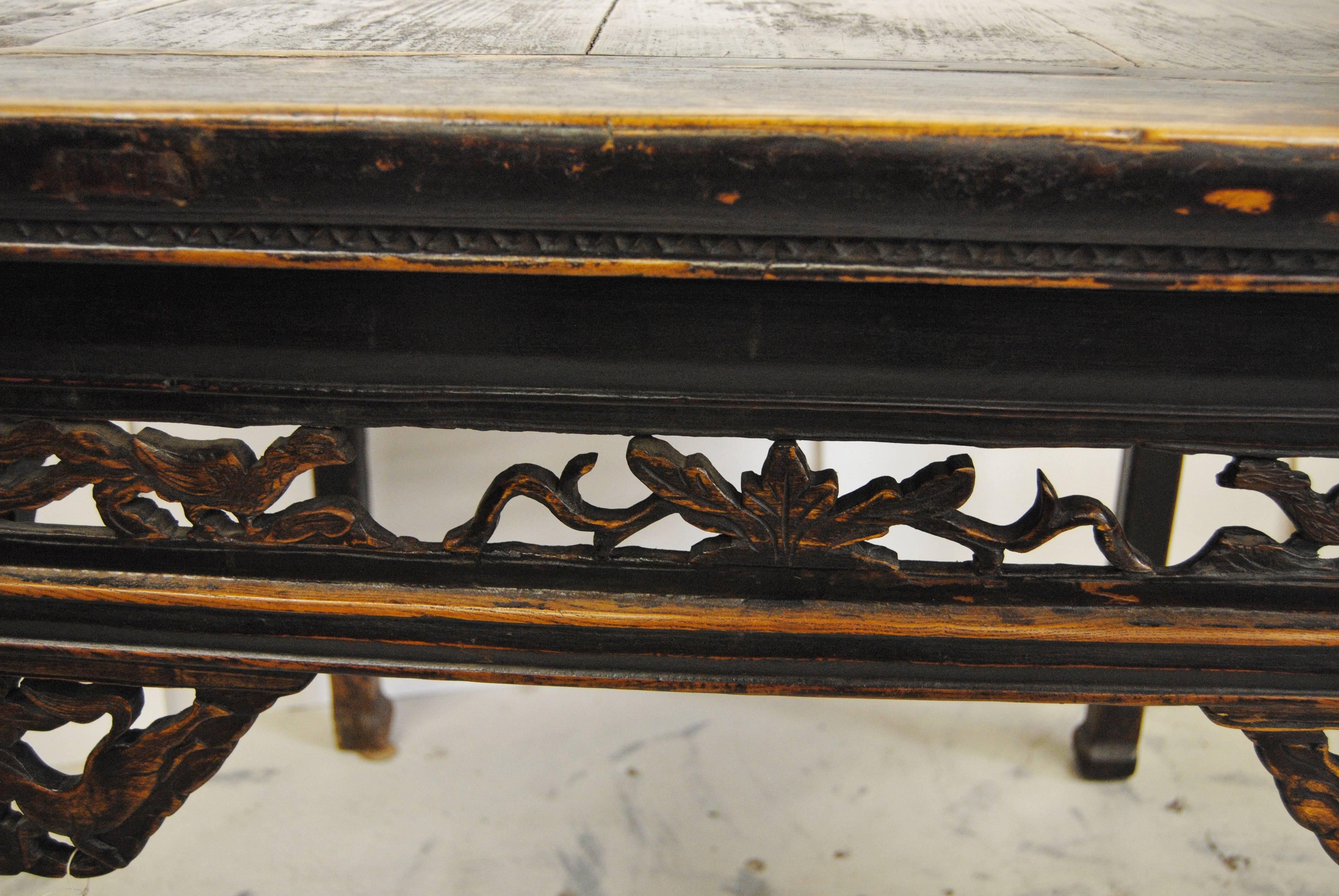 Antique Chinese square elmwood table, mid-19th century. Table has original lacquer finish with eight horse pierce carved side panels and hooved feet. Age appropriate wear that adds to the character of the table. A very rare piece of Chinese history.