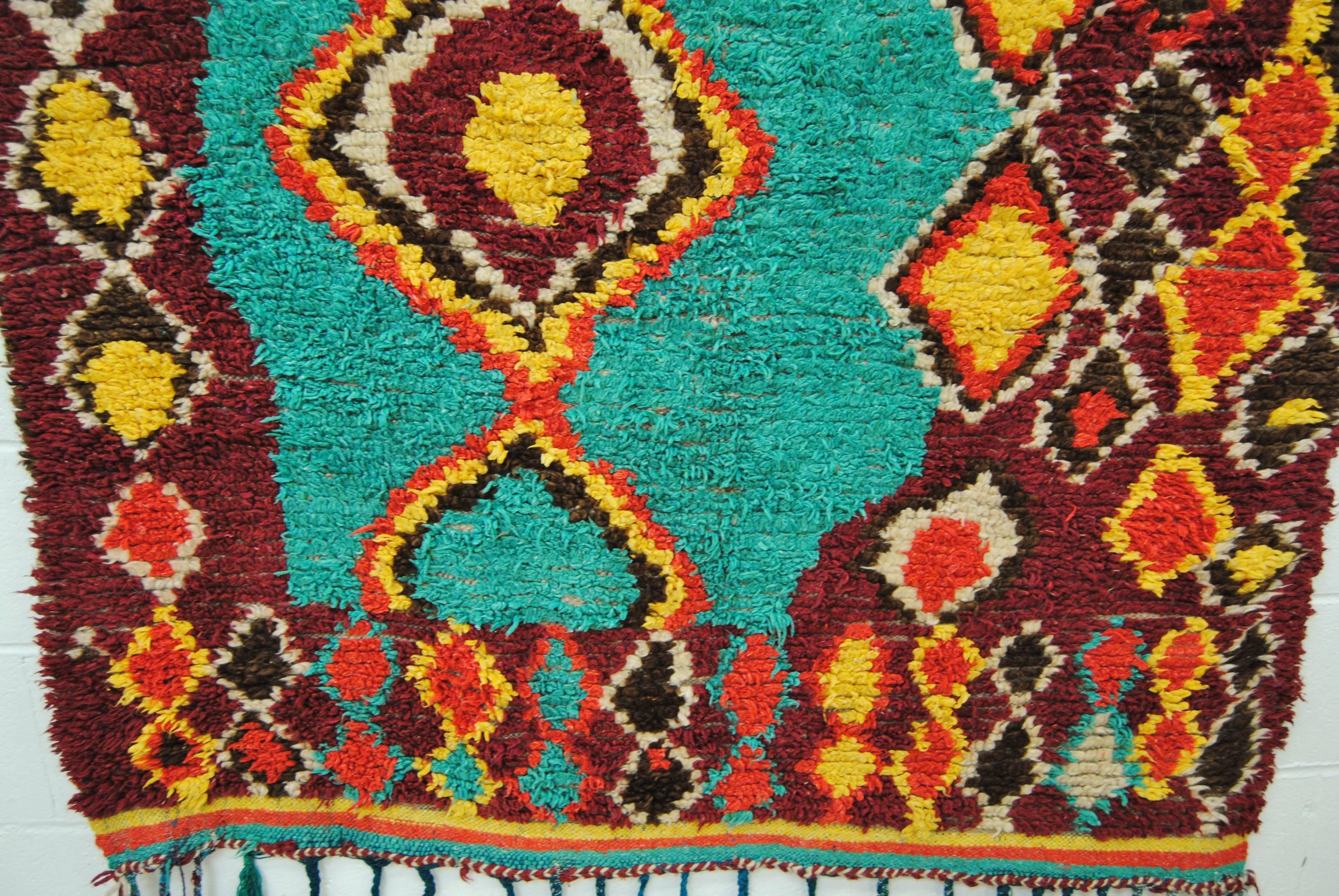 Vintage Moroccan hand-loomed wool Azilal rug made by the Berber women of the Atlas Mountains. Vibrant, rich color with tribal motifs. Very little wear.