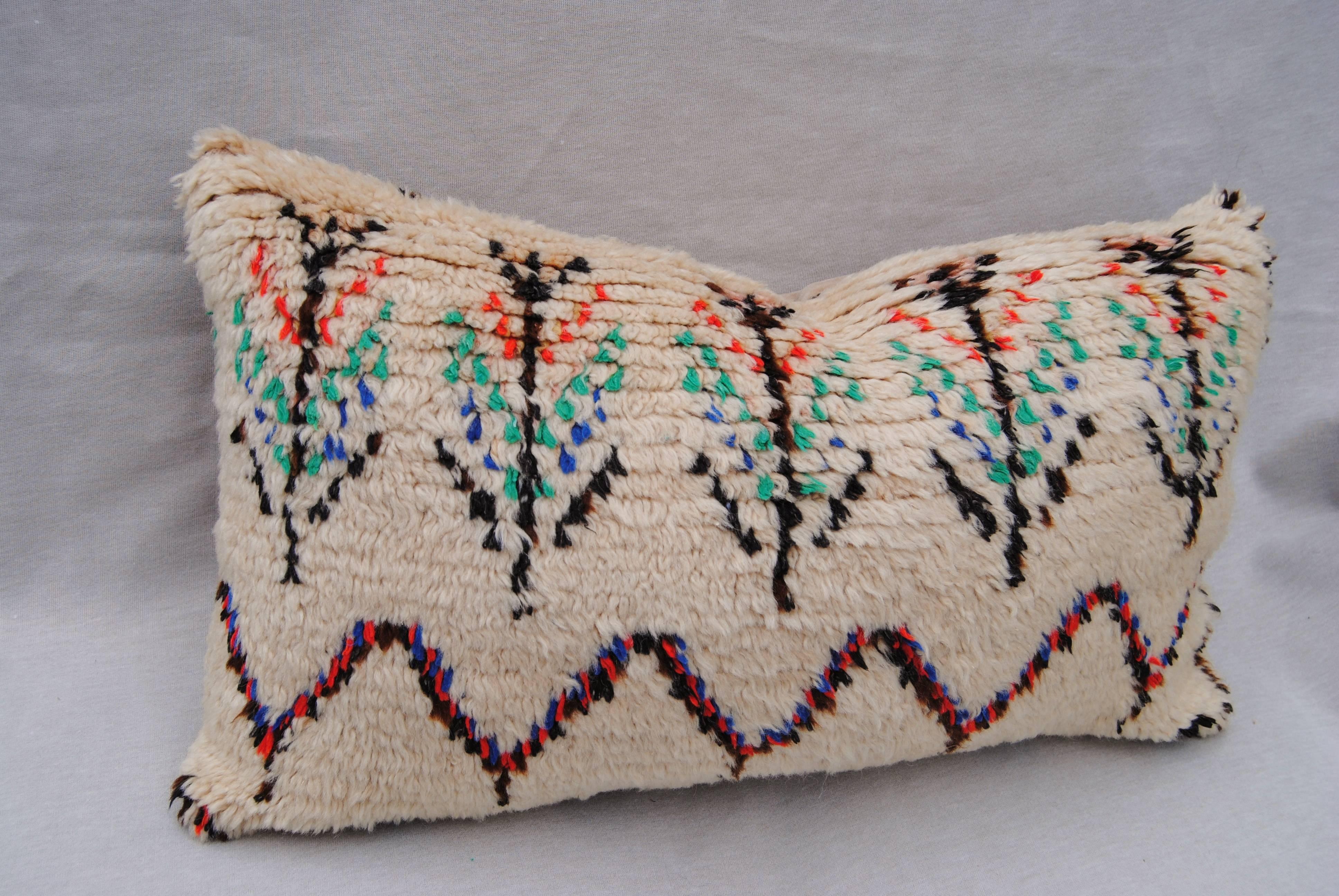 Custom pillow cut from a vintage hand-loomed wool Azilal Moroccan rug from the Atlas mountains. The wool textile is very soft and lustrous with all natural dyes. Pillow is backed in a cream mohair, filled with an all down insert and hand-sewn