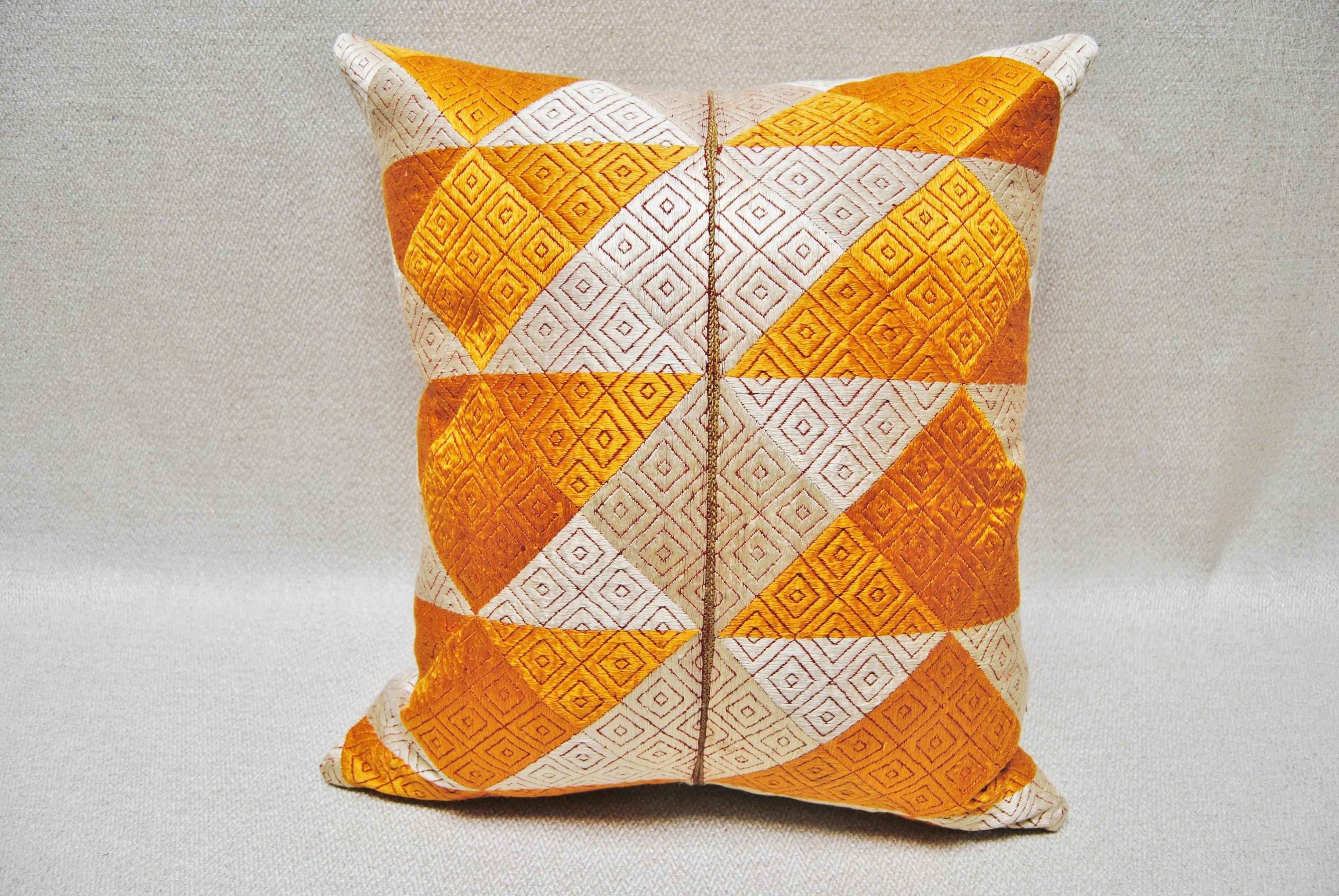 Custom pillow cut from a vintage hand embroidered Phulkari Bagh wedding shawl from Punjab, India. The shawl is hand embroidered with vibrant silk threads on hand-loomed cotton khadi cloth, covering the entire cloth with color. It is made by members