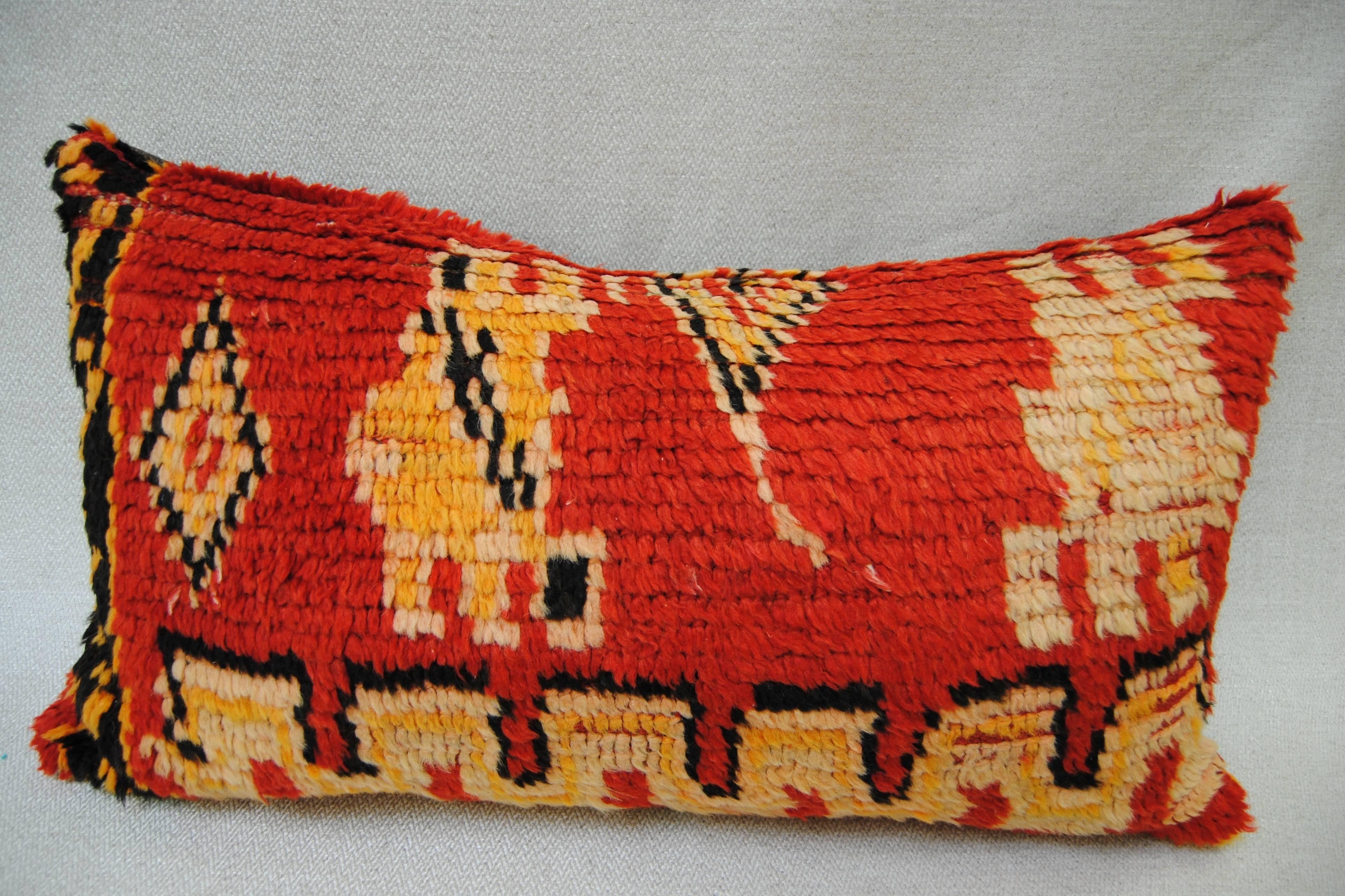 Custom pillow cut from a vintage hand-loomed wool Moroccan Berber rug. The rug is from Rhamna and over 65 years old. Strong tribal designs with vibrant color and a soft, lustrous hand. The pillow is backed in a dark brown linen, filled with an