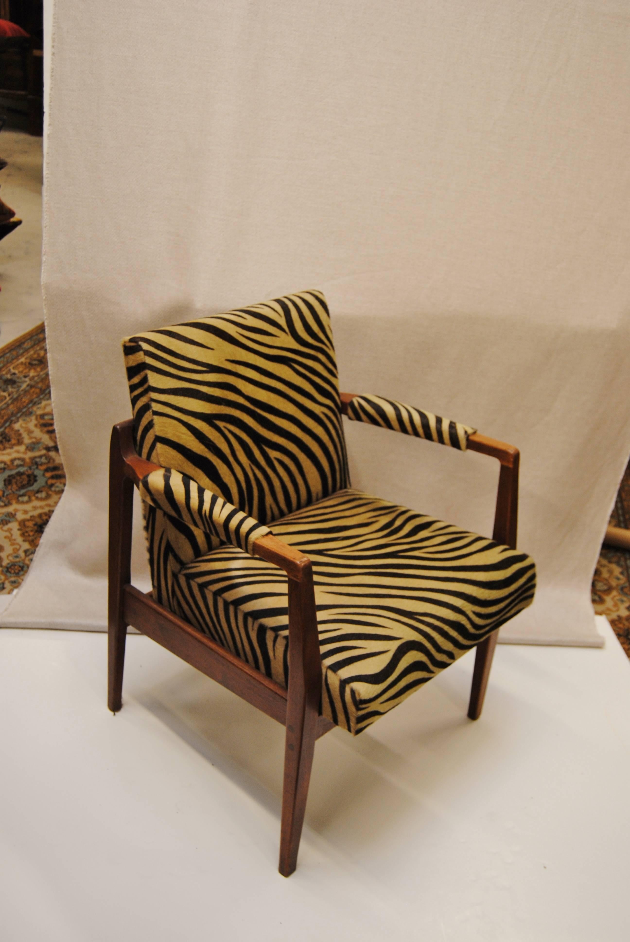 Vintage Danish modern walnut armchair, restored and upholstered in Edelman zebra cowhide. This is a heavy, comfortable chair with good design. Perfect accent chair for an eclectic style room.