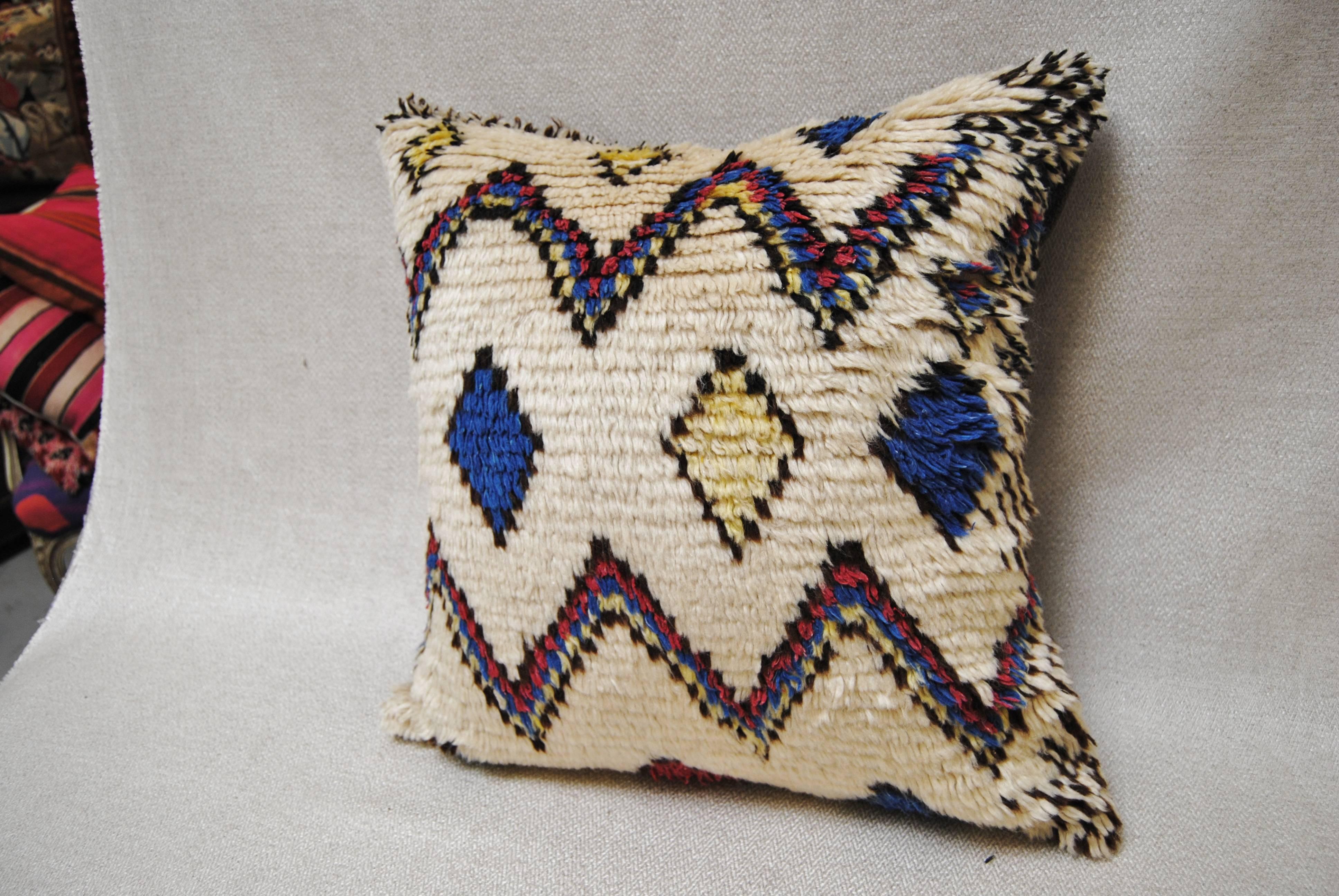 Custom pillow cut from a vintage Moroccan hand-loomed wool Azilal rug made by the Berbers of the Atlas Mountains. Soft lustrous wool with all natural dyes. Pillow is backed in a cream mohair, filled with an insert of 50/50 down and feathers and