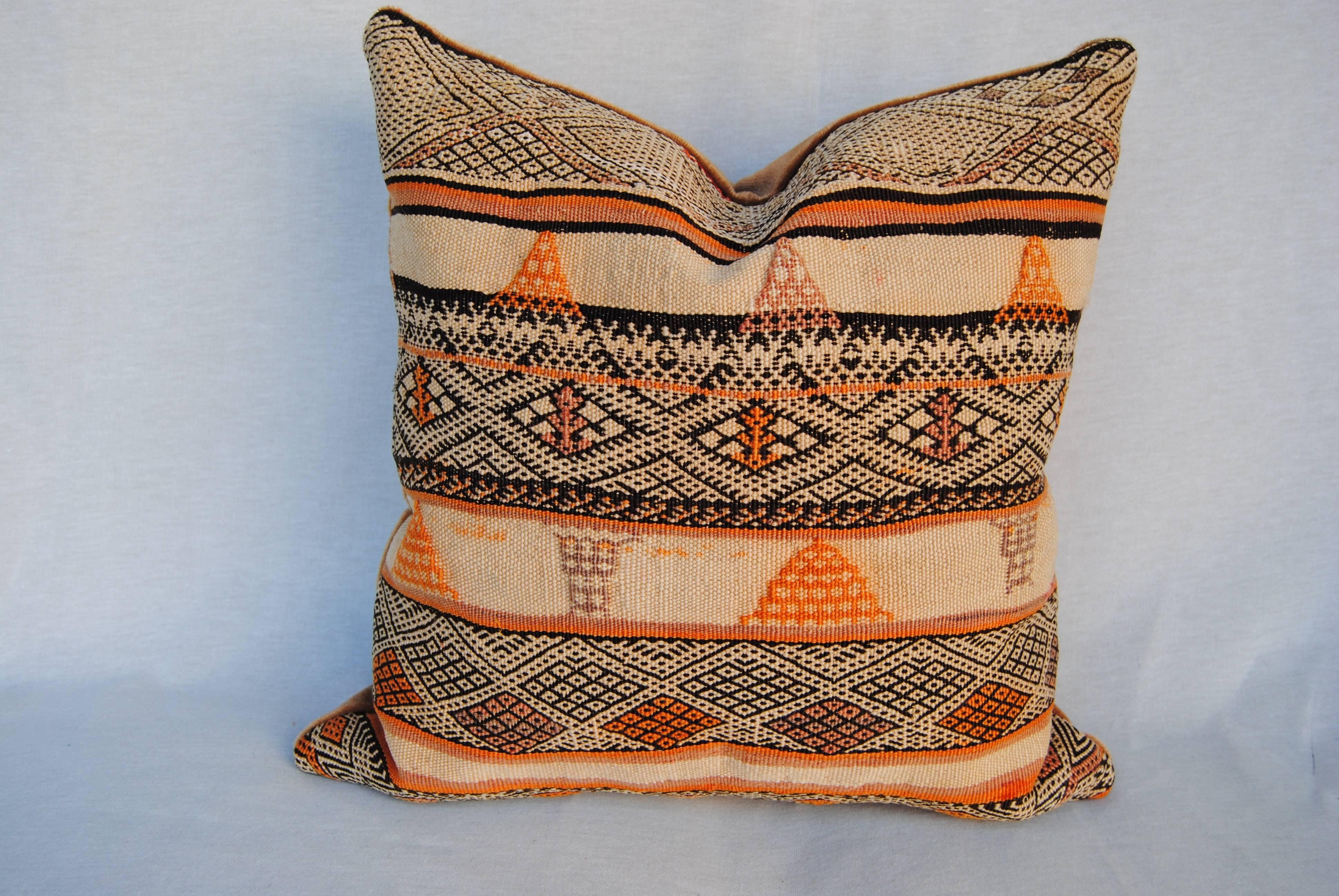 Custom pillow cut from a hand loomed wool Moroccan Berber rug from the Atlas Mountains. It is very heavy, thickly woven textile and was probably used as a large storage bag for bedding and clothes. All natural dyes. Pillow is backed in a mustard