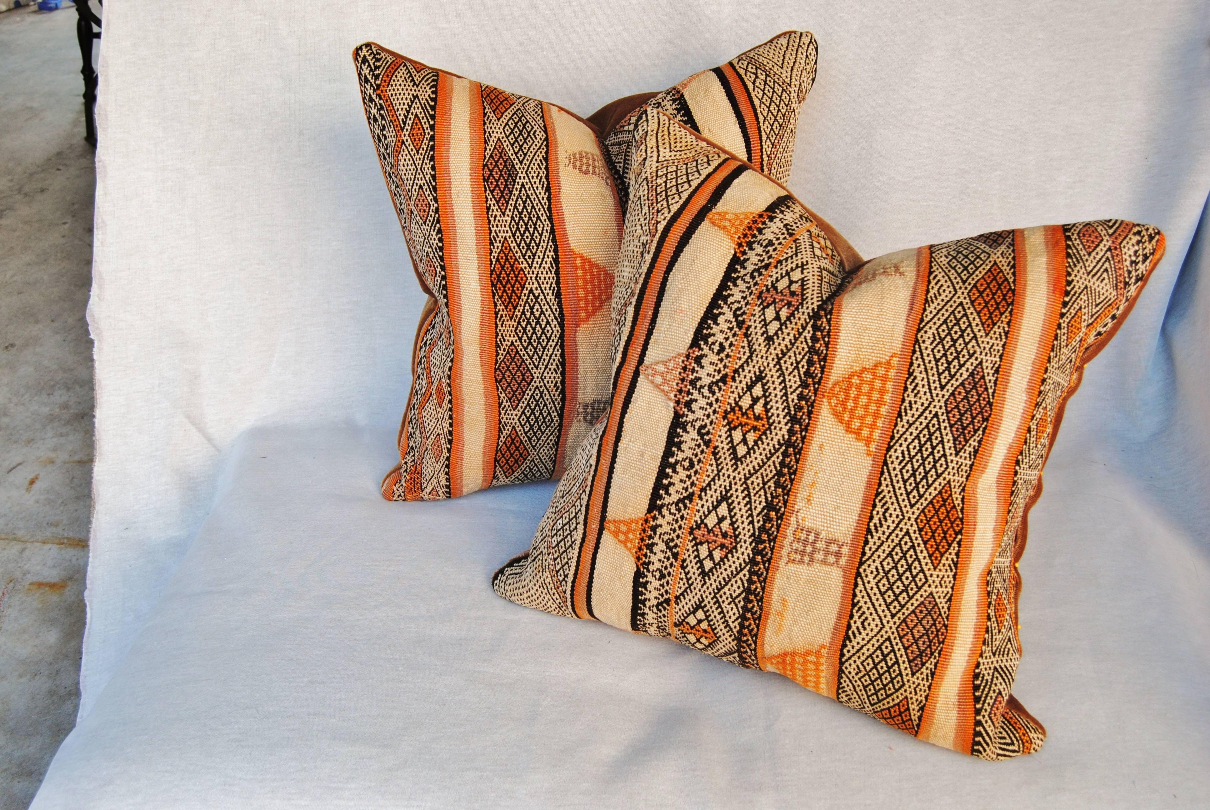 Custom pillow cut from a vintage hand-loomed wool Moroccan rug made by the Berber women of the Atlas Mountains. This was a very heavy, thickly woven textile probably used as a storage bag for bed linens and clothing. Pillow is backed in a mustard