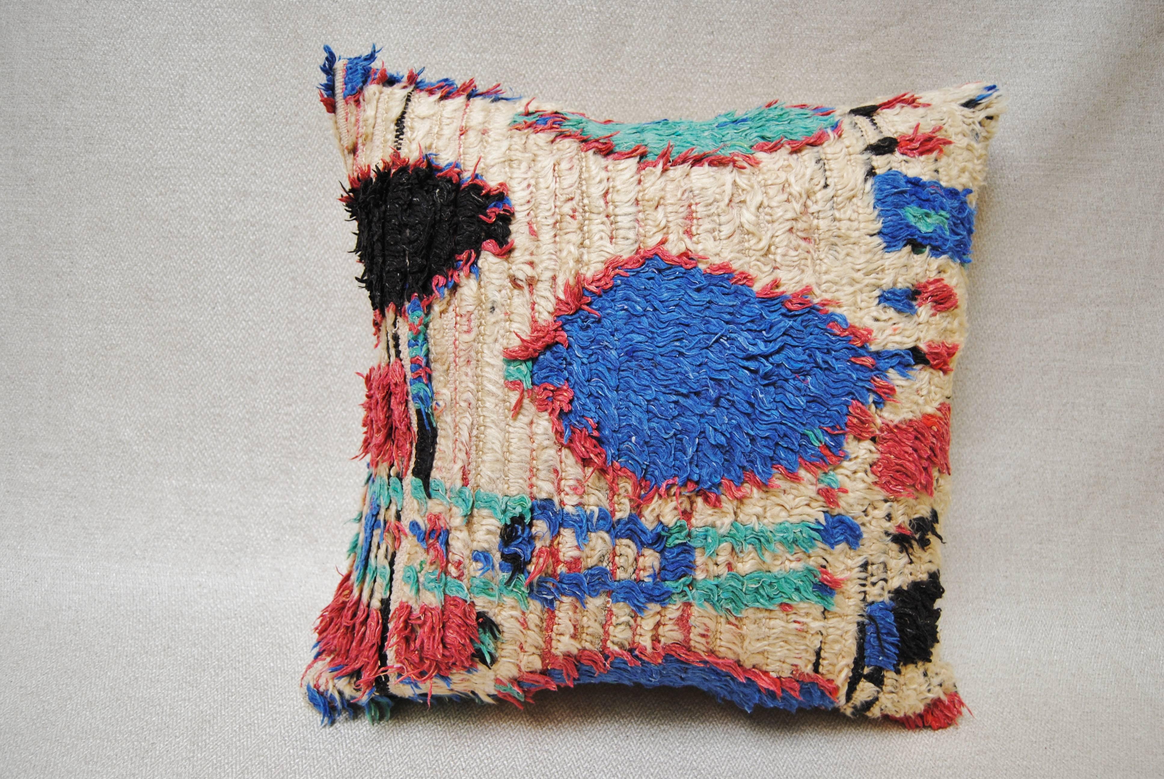 Custom pillow cut from a vintage hand loomed wool Moroccan Azilal Rug from the Atlas Mountains. Wool textile is soft and lustrous with vividly colored tribal designs. Pillow is backed in a linen blend, filled with an insert of 50-50 down and