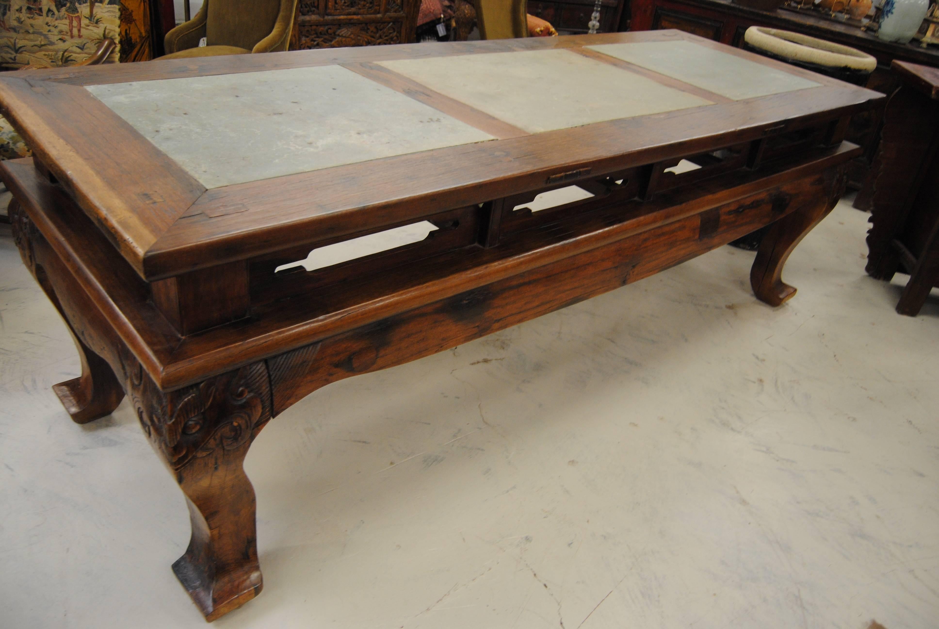 19th century ironwood Chinese scholar's table. The table has slate inserts and ledges along the sides to hold the calligraphy inks. Outstanding hand-carved faces on the four legs. Extremely heavy table. Perfect for the wine cellar tasting room!