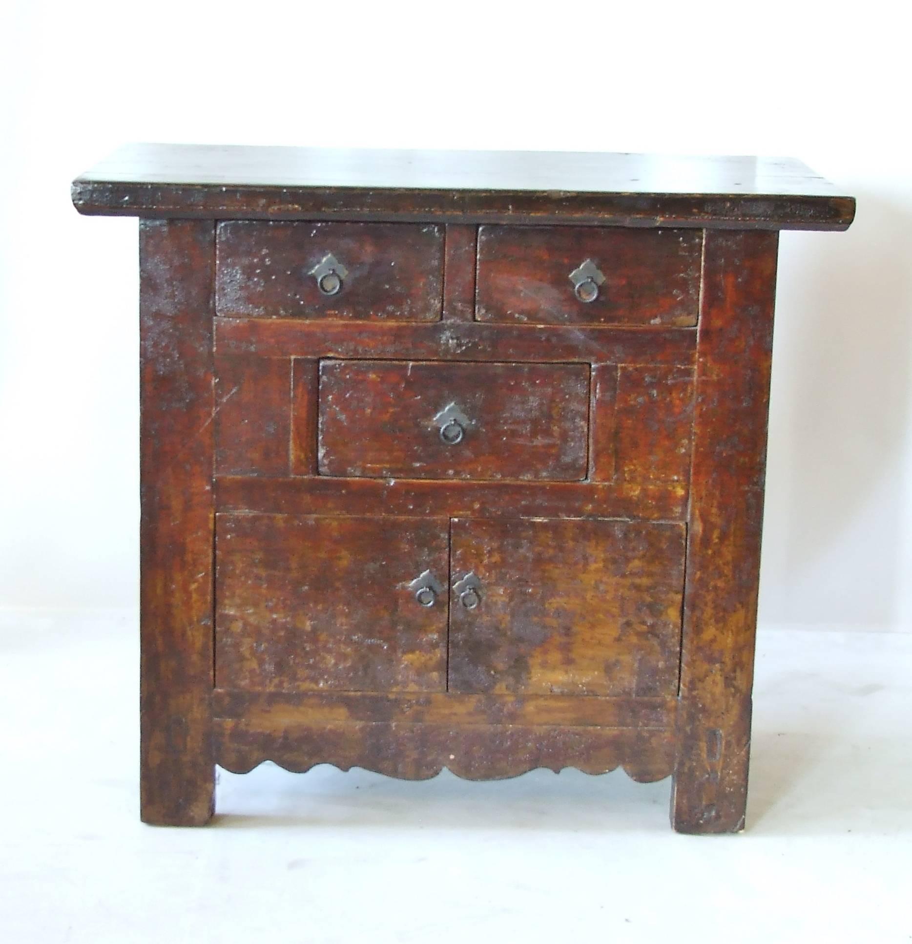 Antique Chinese elmwood coffer with original lacquer with rich chestnut tones. The Asian cabinet has three small drawers and a lower opening with two doors. The clean straight lines are complimented with the whimsical carving on the lower front