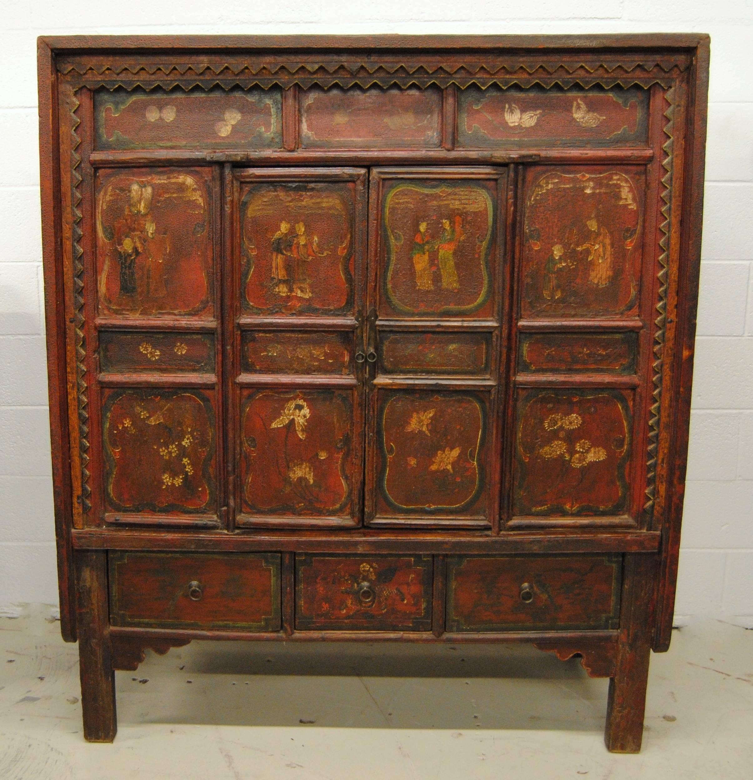 Antique Chinese 19th century Shanxi province armoire. The Asian cabinet has incredible figural designs and strong original color. The armoire has two doors that open out with an inside shelf and three lower drawers. All hand hewn with zig zag