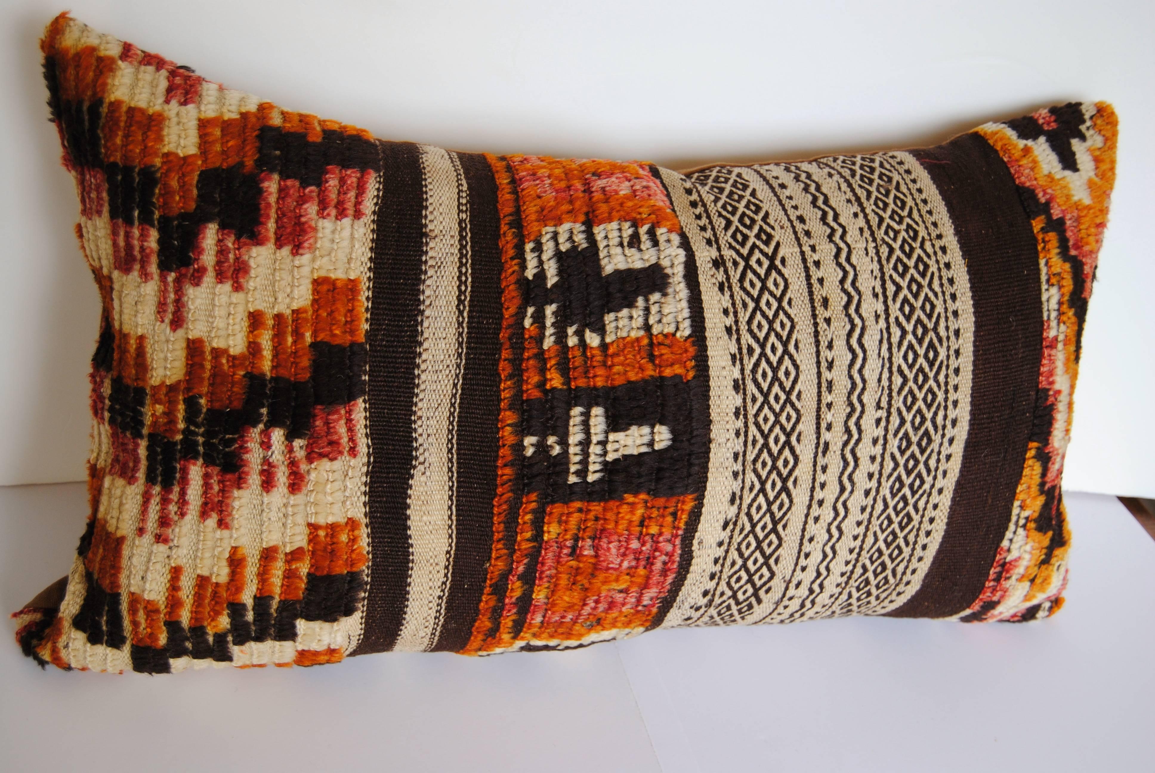 Custom pillow cut from a vintage hand-loomed wool Moroccan Berber rug from the Atlas Mountains. Soft lustrous wool in all natural dyes. Pillow is backed in a caramel linen, filled with an insert of 100% down and hand-sewn closed.