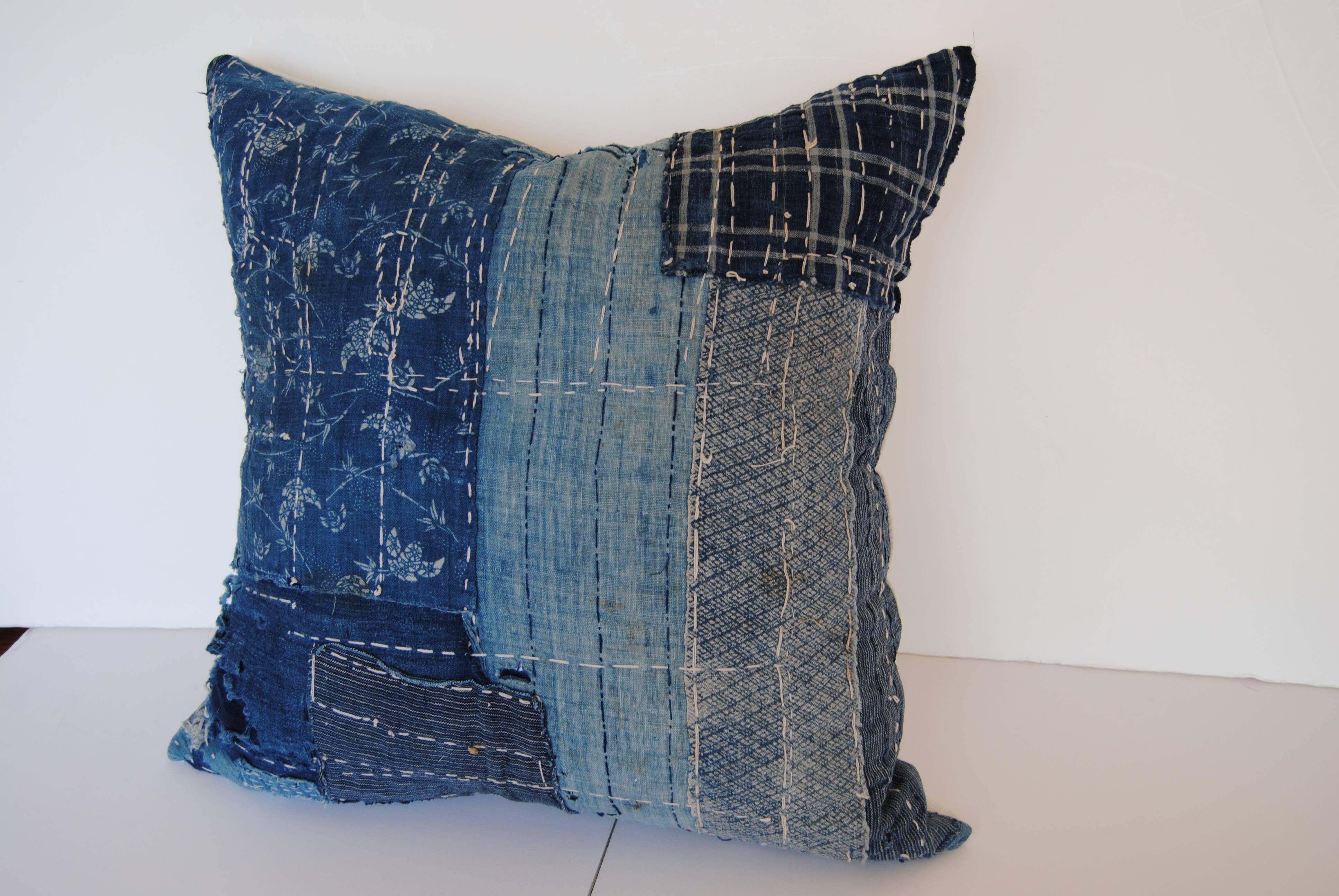 Custom pillow cut from an antique Japanese boro futon cover. The boro, meaning rags, has hand loomed cotton indigo textiles from the late 1800s to early 1900s. In some places there are up to 6 layers of cotton to cover the wear, all held together