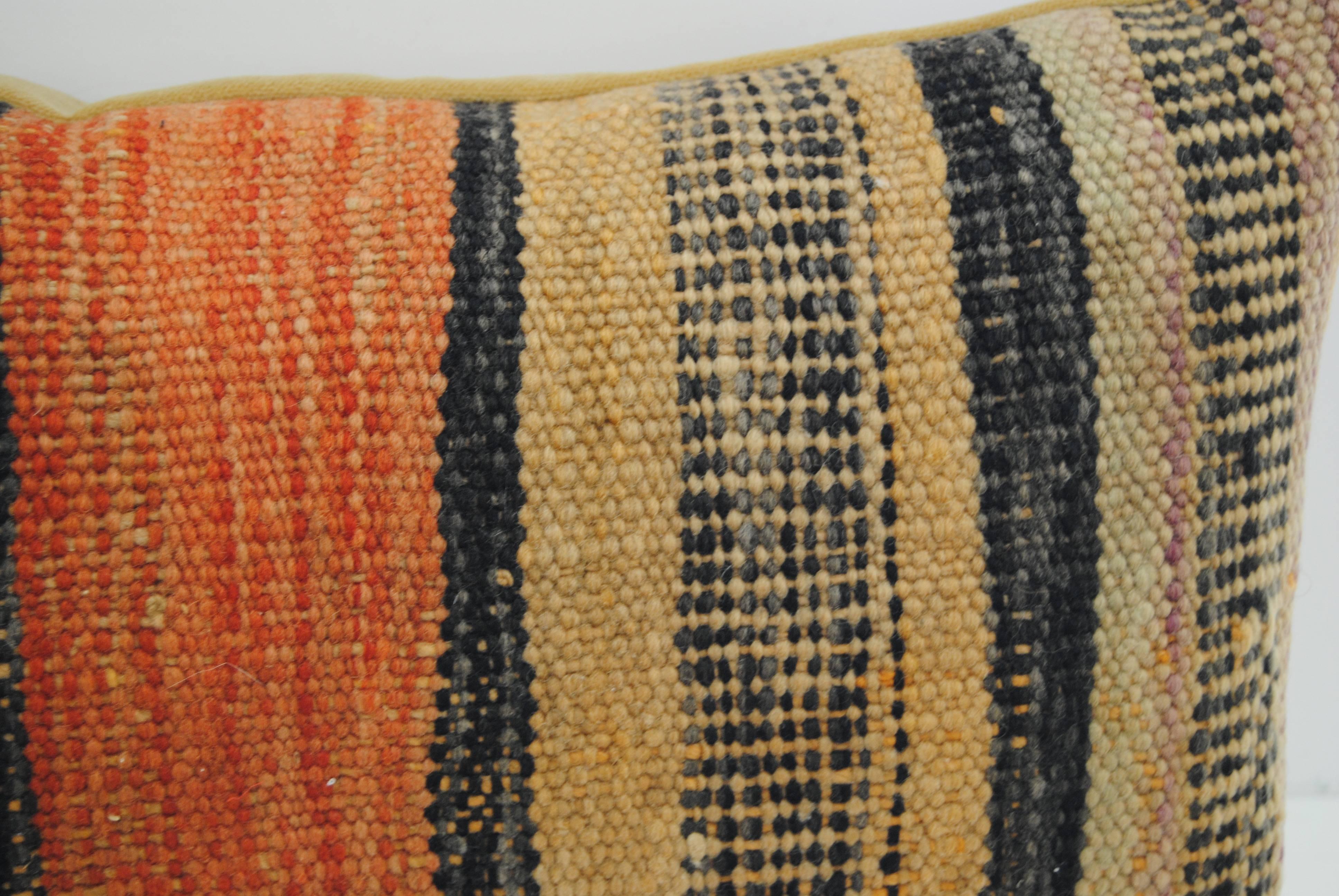 Custom pillow cut from a vintage hand loomed wool Moroccan rug from the Atlas Mountains. Wool is soft and lustrous with all natural dyes. Pillow is backed in a soft camel velvet, filled with an insert of 50/50 down and feathers and hand-sewn closed.