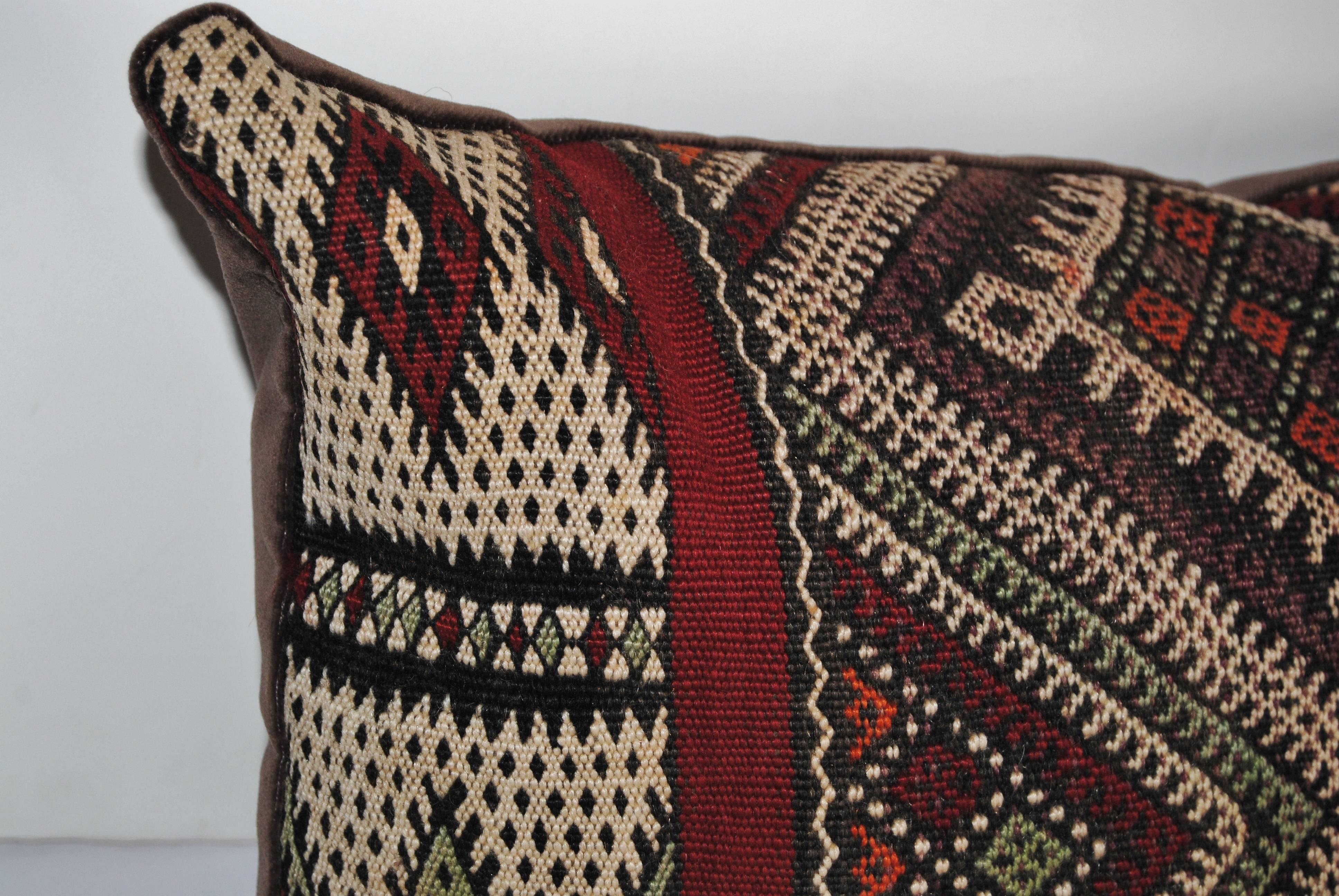 Custom pillow cut from a vintage hand loomed wool Moroccan Berber rug from the Atlas Mountains, wool is soft and lustrous with good color. Pillow is backed in a brown velvet, filled with an insert of 100% down and hand-sewn closed.
Pair available.