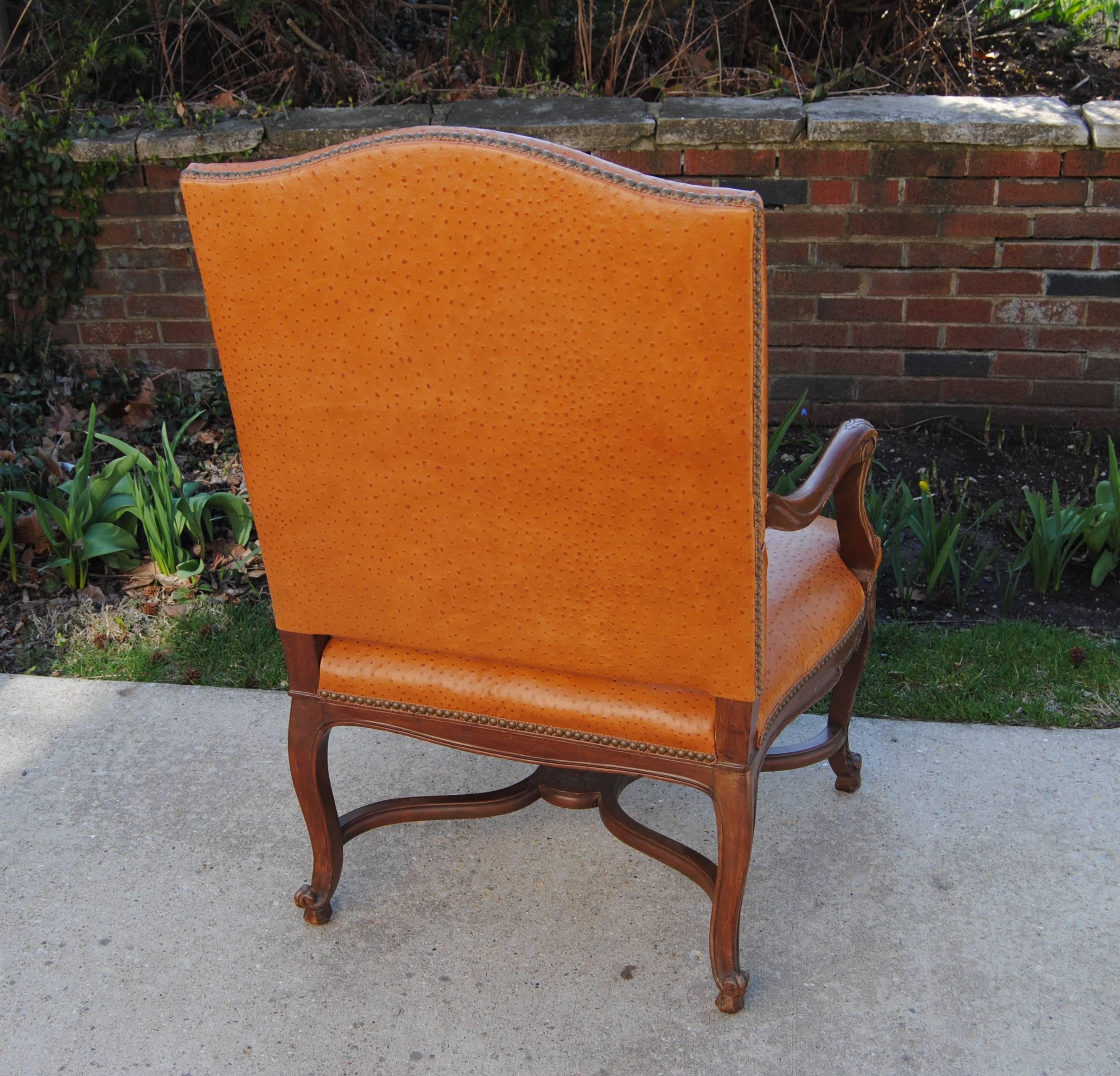 Vintage French fauteuil newly upholstered in Edelman faux ostrich cowhide leather. Chair is finished with vintage gimp and nail head trim. A heavy chair with carved apron and original finish on wood. Early 20th century.