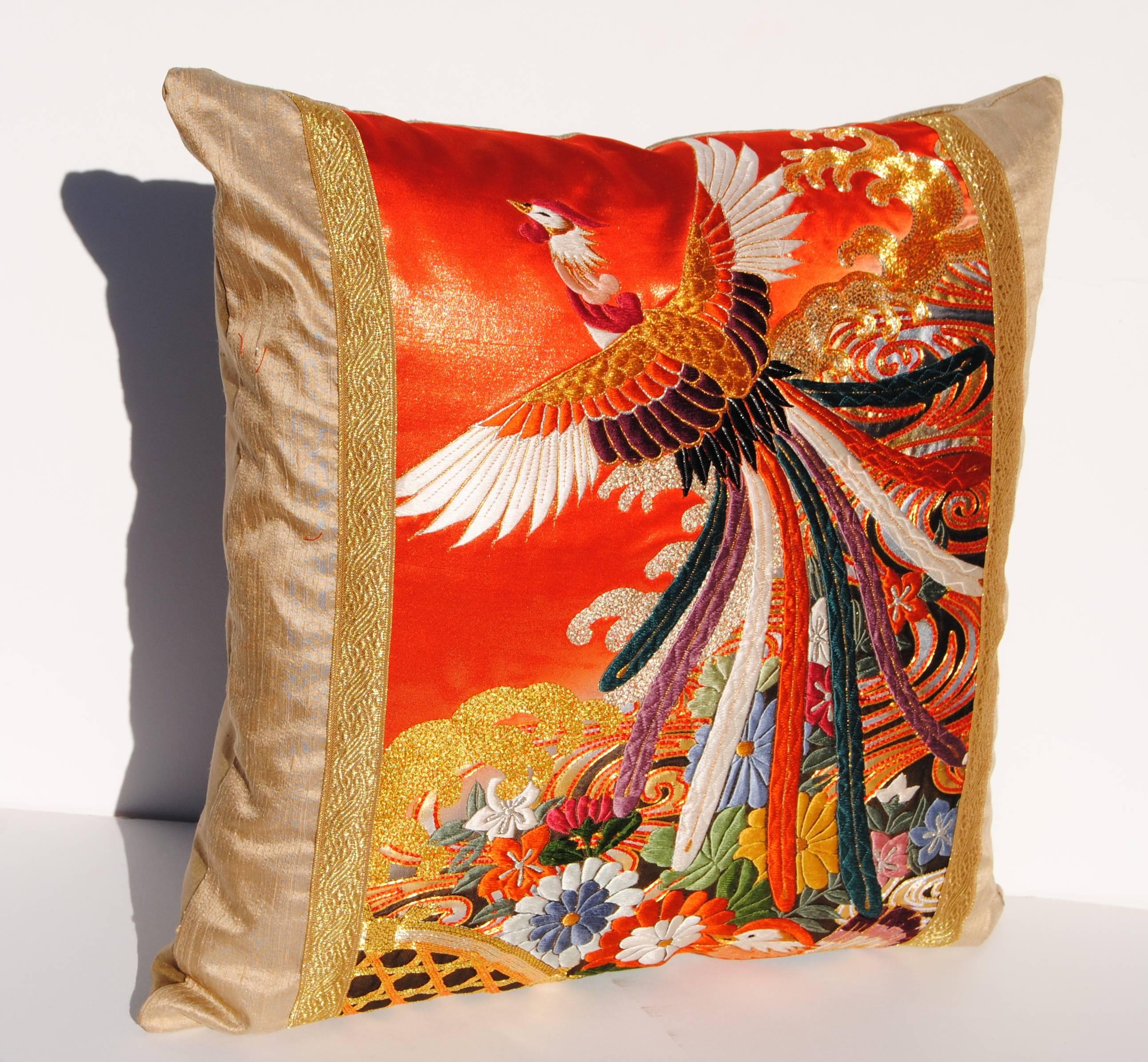 Custom pillow cut from a vintage Japanese silk embroidered uchikake wedding kimono. The orange or red silk is embroidered with silk and metallic threads. The pillow is faced with a cream silk and gold metallic trim. It is backed with a wool or silk,