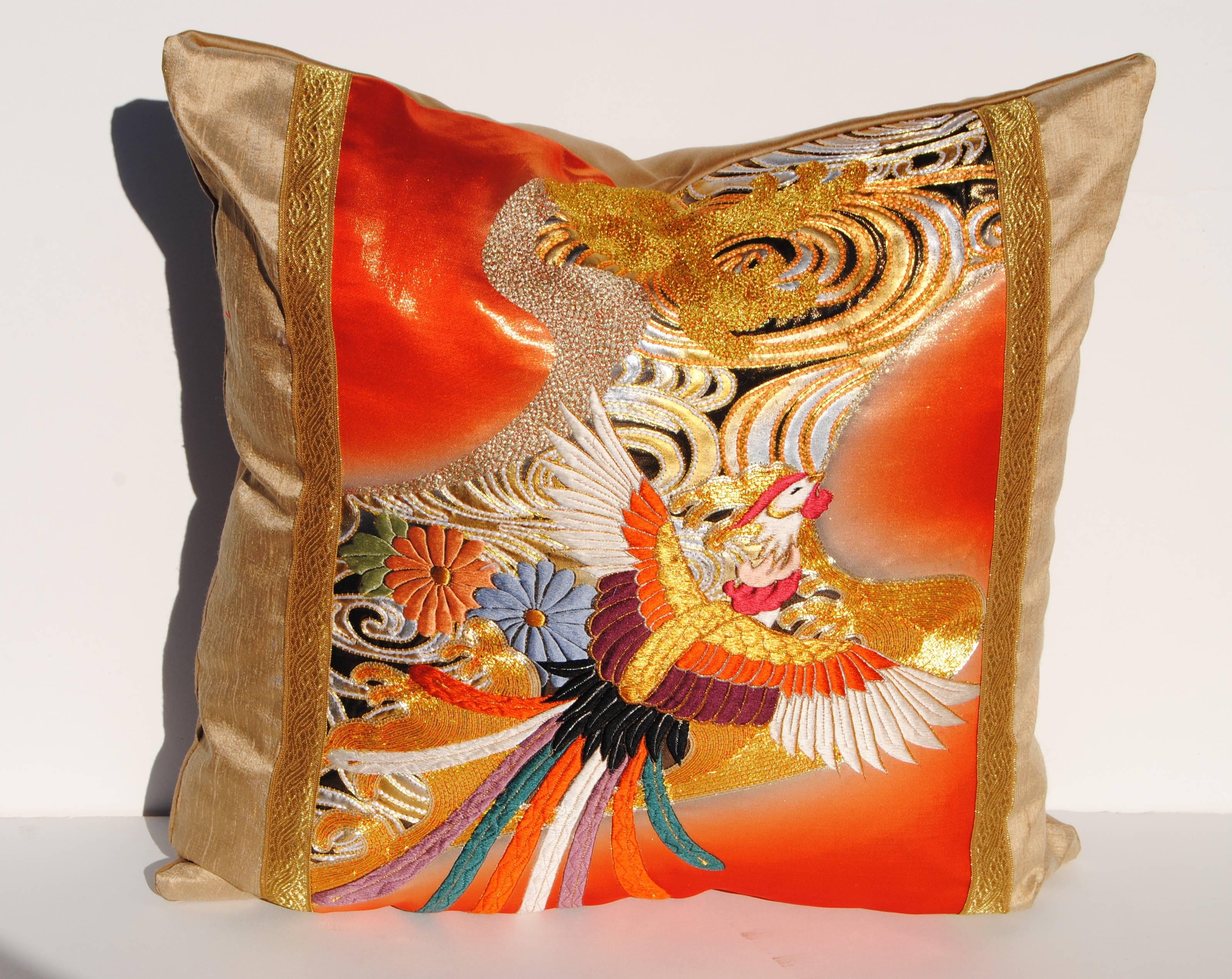 Custom pillow cut from a vintage embroidered silk Japanese uchikake wedding kimono. The red or orange silk is embroidered with silk and metallic threads. The pillow is faced with a cream silk and bands of gold metallic trim. It is backed with a wool