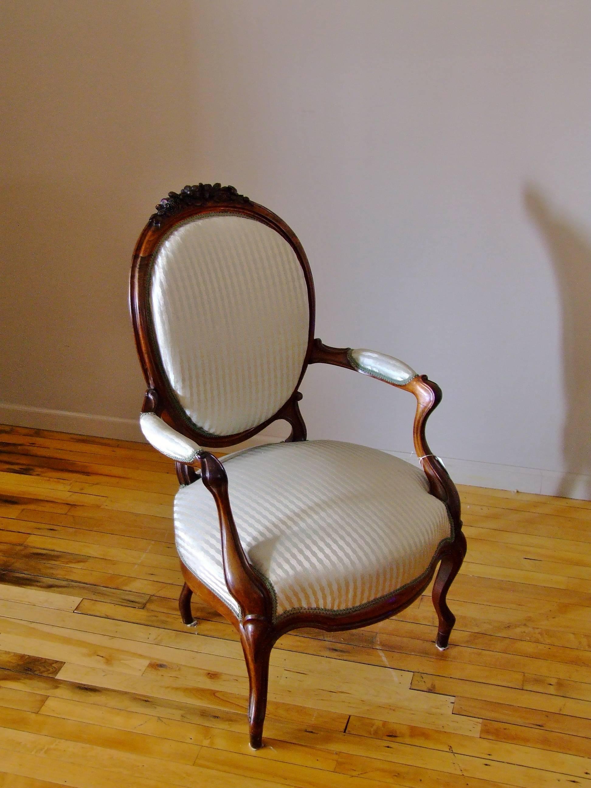 Antique European hand-carved rosewood chair with fine hand-carved details. Chair has been newly upholstered in a Scalamandre silk stripe in soft blue and silver with antique gimp. Wood in very good original condition.
                      