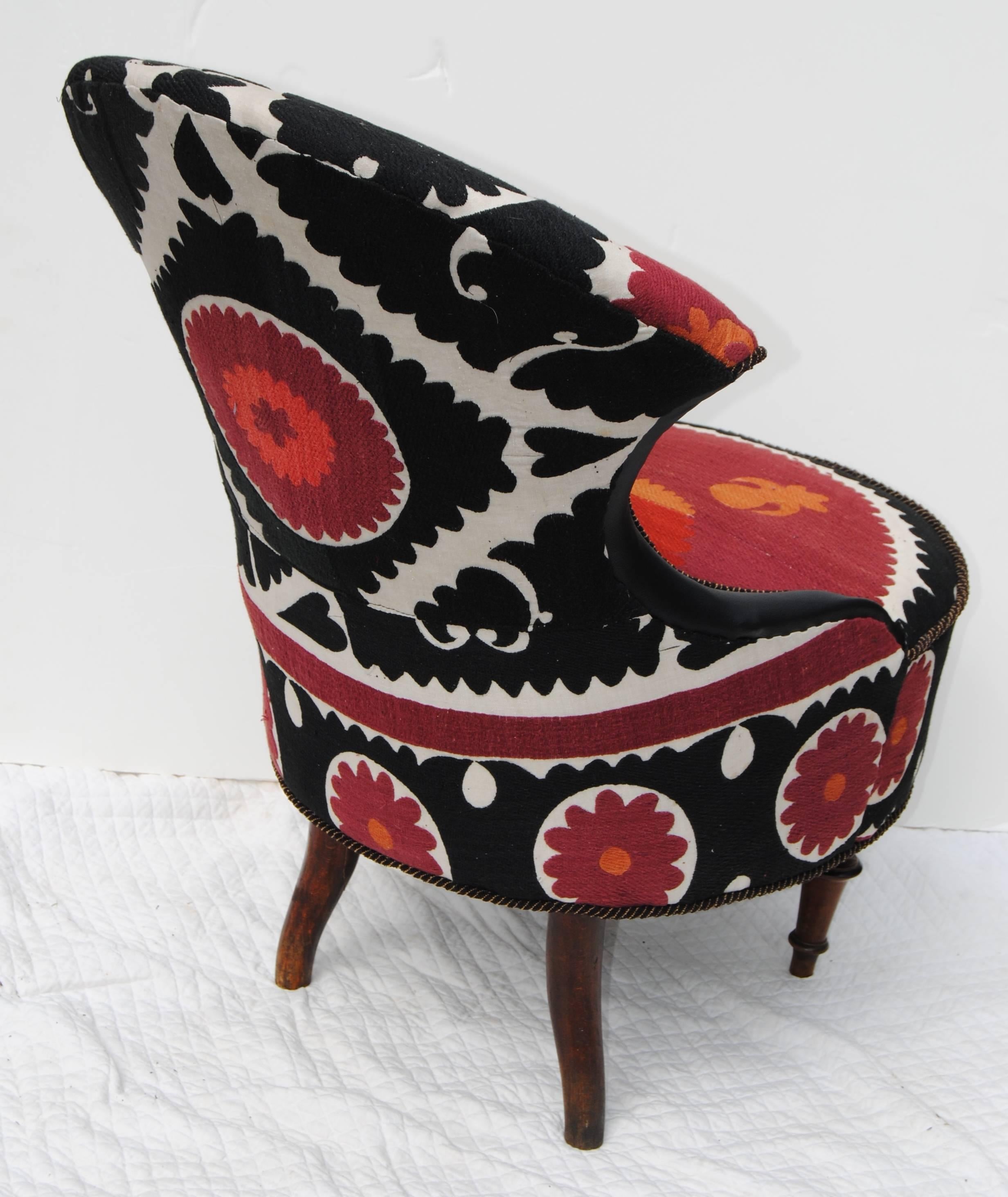 Antique European chair, circa mid-late 1800s, restored and newly upholstered in a vintage hand embroidered Suzani textile. This is a small-scale chair with very unusual design details, a piece of Folk Art with curved lines accented by the placement