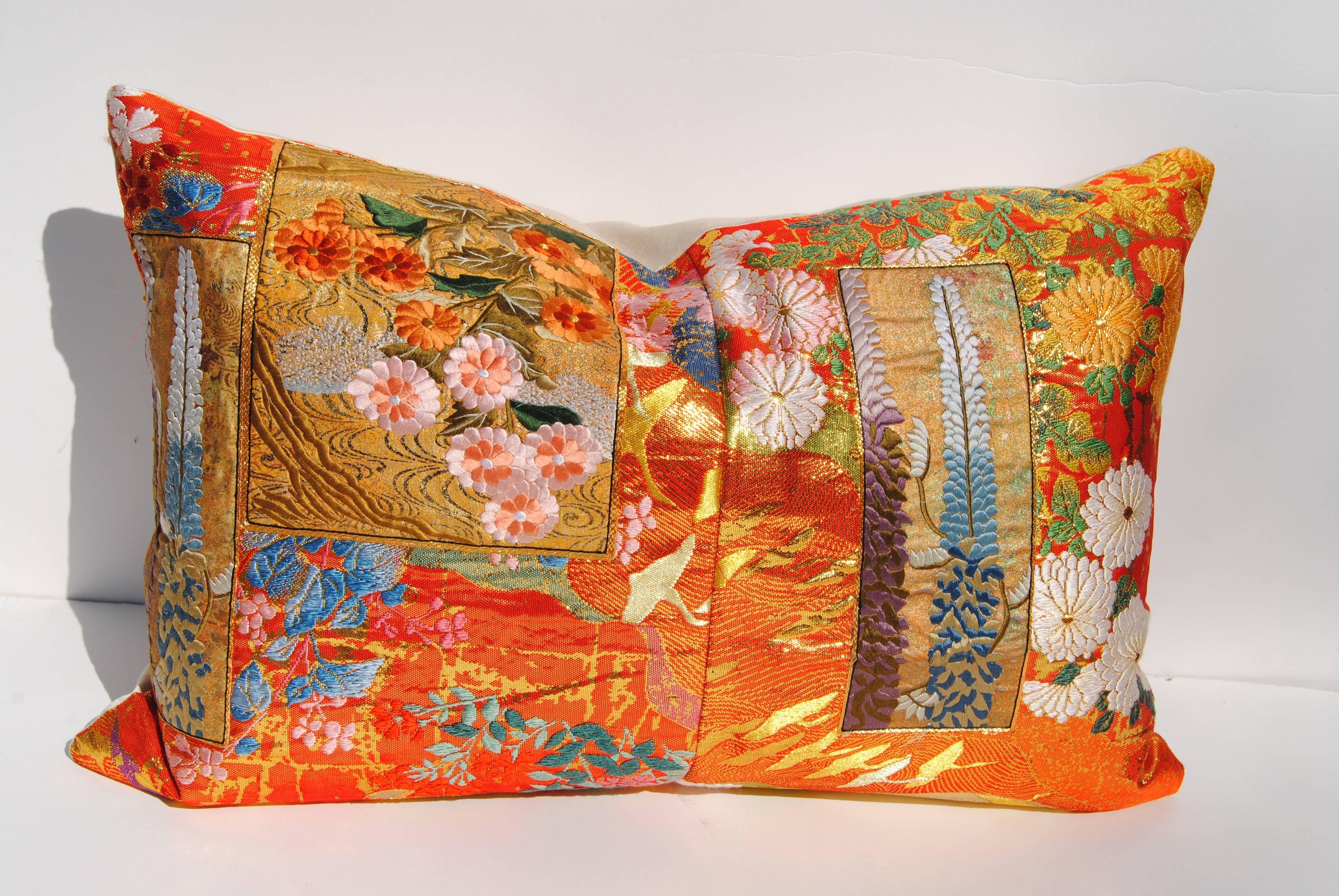 Custom pillow cut from a vintage Japanese silk uchikake, the traditional wedding kimono. The silk textile has a metallic thread background with florals and birds woven into the design. Finely embroidered silk patchwork adds exuberance to the