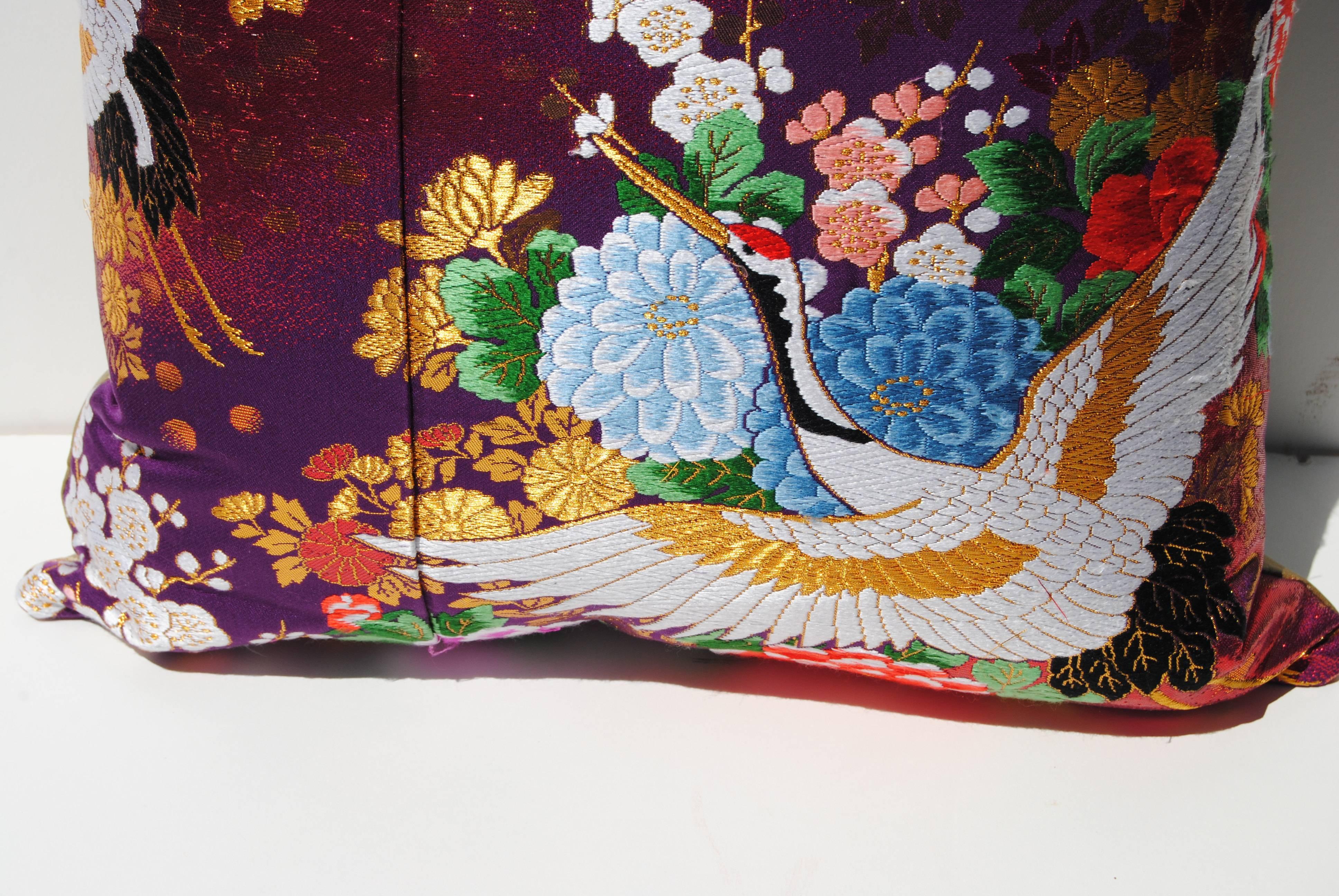 Custom pillow cut from a vintage silk Japanese uchikake, the traditional wedding kimono. Pillow has vibrant color with traditional Japanese designs. It is backed in a putty color silk, filled with an insert of 50/50 down and feathers and hand-sewn