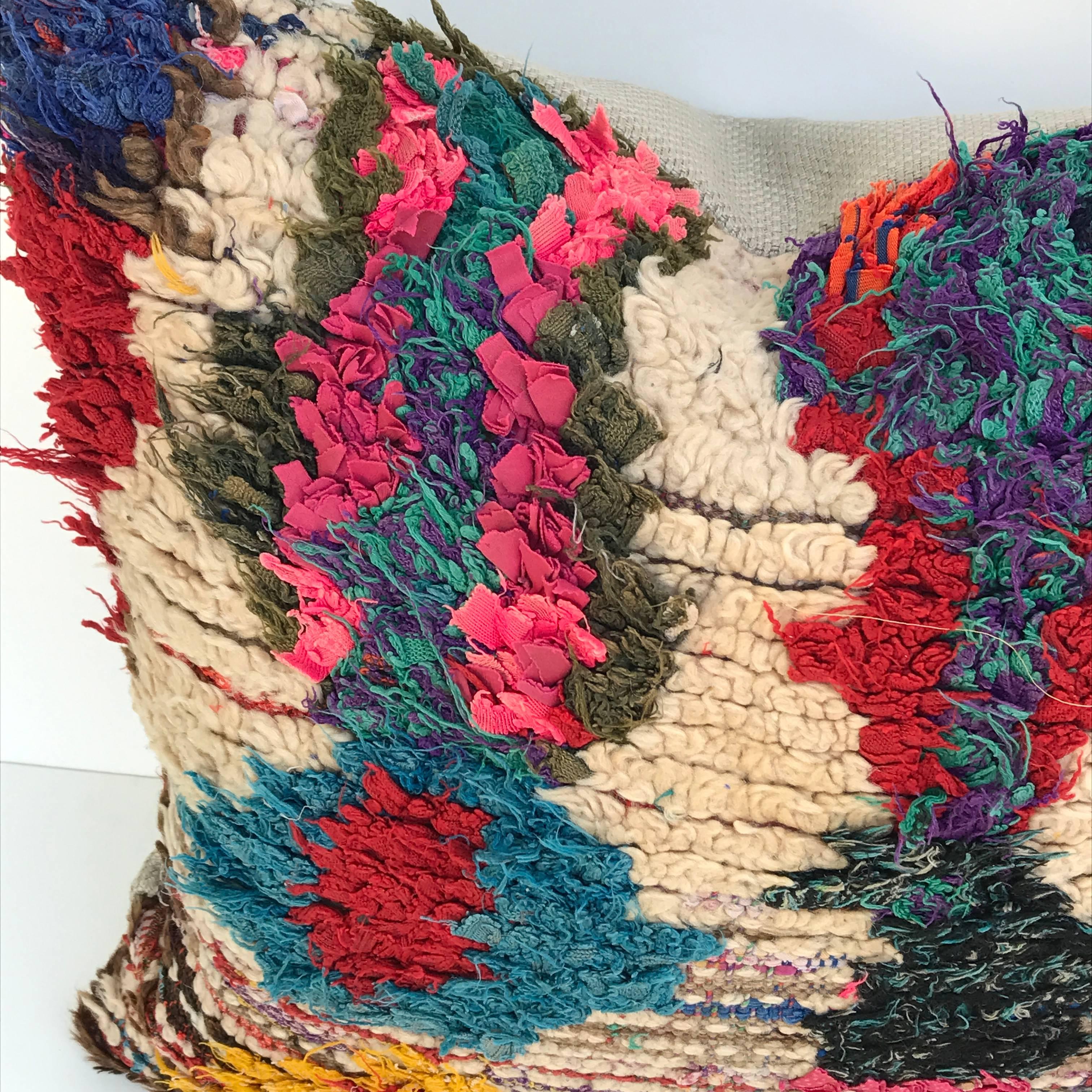 Custom pillow cut from a vintage hand-loomed Moroccan Berber rug from the Atlas Mountains. Wool is soft and lustrous with brightly colored tufting. Pillow is backed in a putty colored linen, filled with an insert of 50/50 down and feathers and