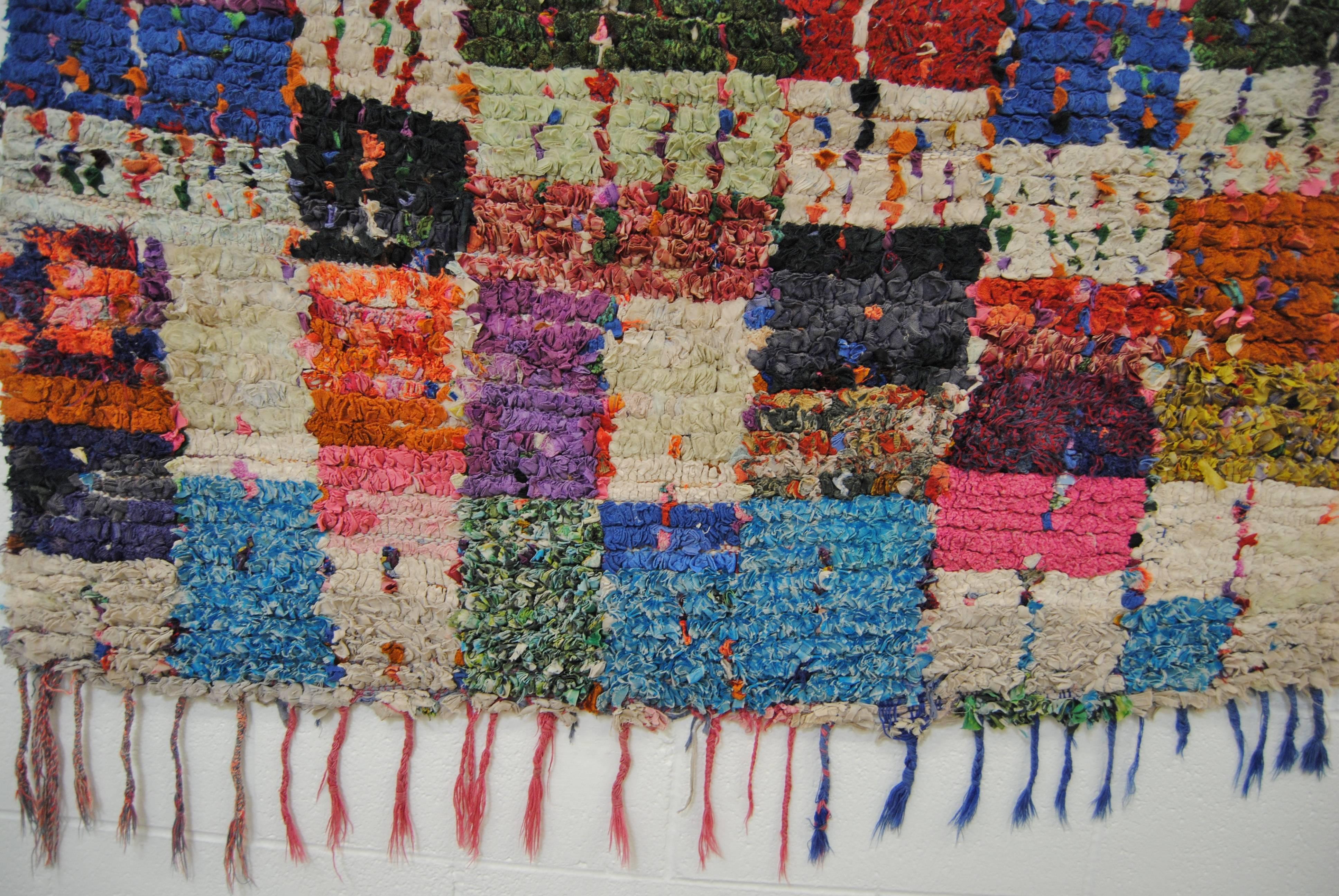 Moroccan hand-loomed Boucherouite rug made in the Atlas Mountains. This heavy rug is made from cotton and other recycled textiles by the Berber tribes. Vibrant color is common in the boucherouite rug. Recently professionally cleaned, for floor or