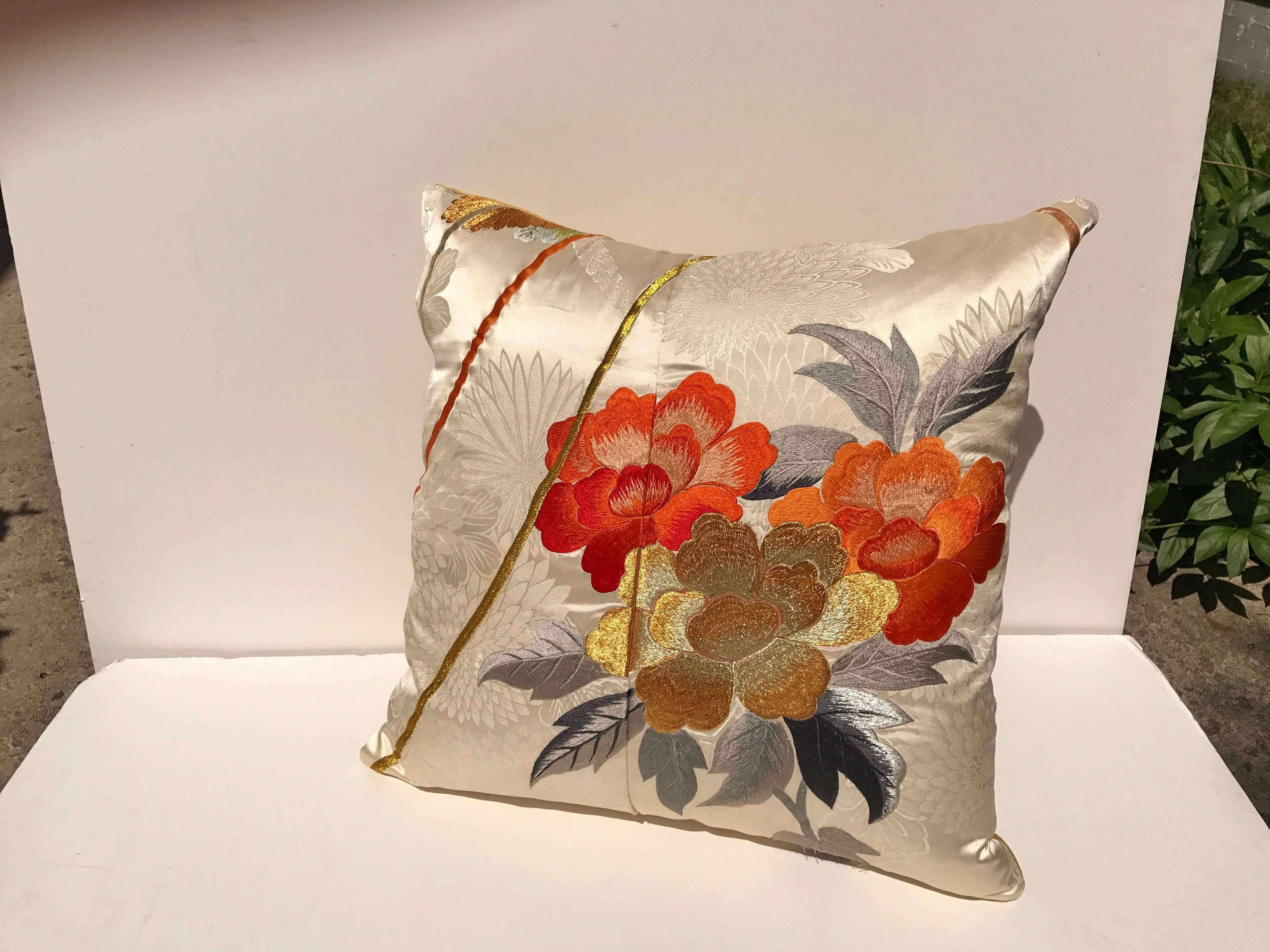 Custom pillow cut from a vintage Japanese silk uchikake, the traditional wedding kimono. Ivory silk is embroidered with colorful silk and metallic threads. Pillow is backed in a soft gold silk, filled with an insert of 50/50 down and feathers and