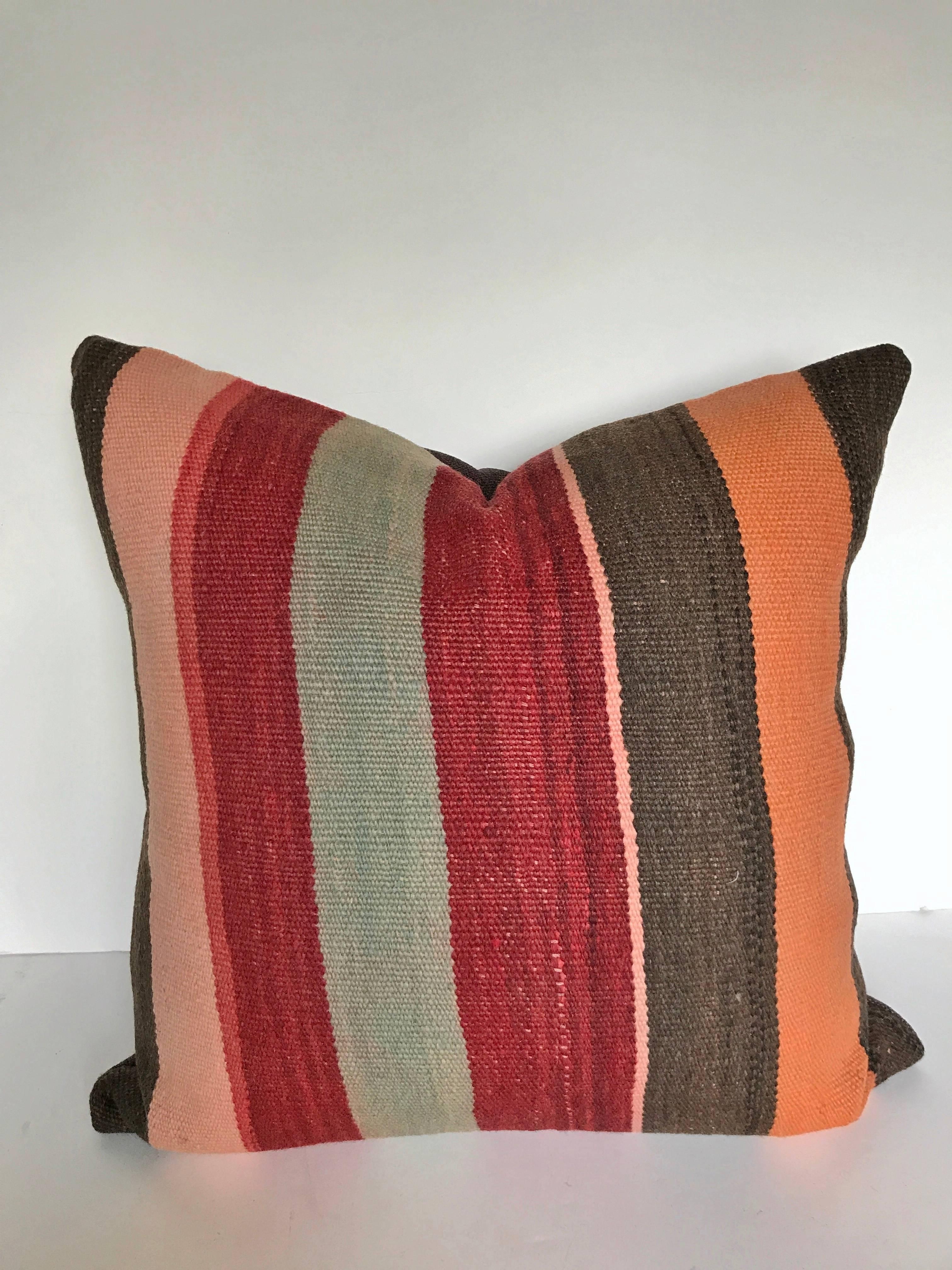 Custom pillow cut from a vintage hand loomed wool Moroccan rug made by the Berber women of the Atlas Mountains. Wool is soft and lustrous with natural dyes. Pillow is backed in a dark brown linen blend, filled with an insert of 50/50 down and