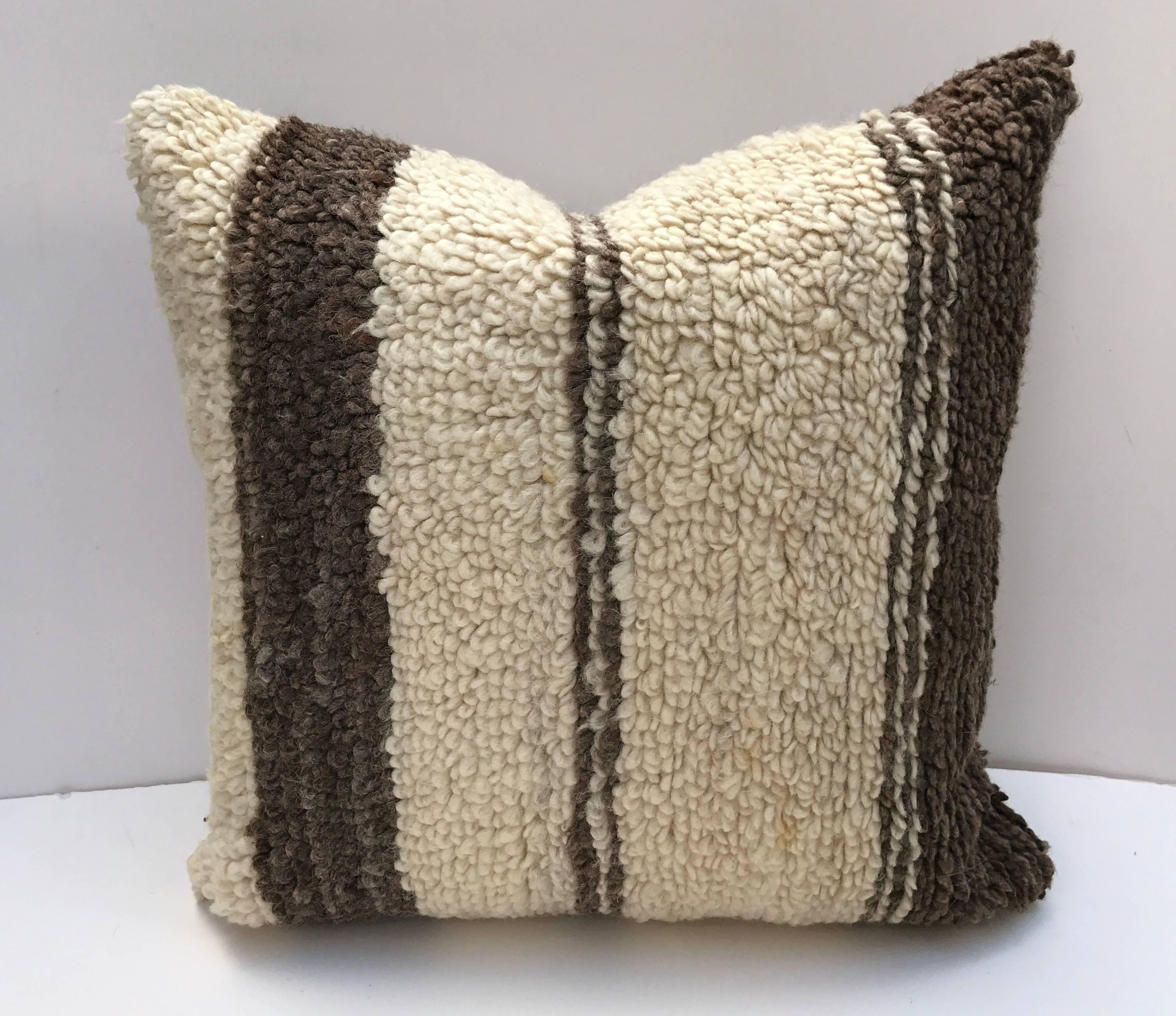 Custom pillow cut from a vintage hand loomed wool Moroccan Beni Ouarain Berber rug from the Atlas Mountains. Wool is soft and lustrous with all natural color. Pillow is backed in linen, filled with an insert of 50/50 down and feathers and hand sewn