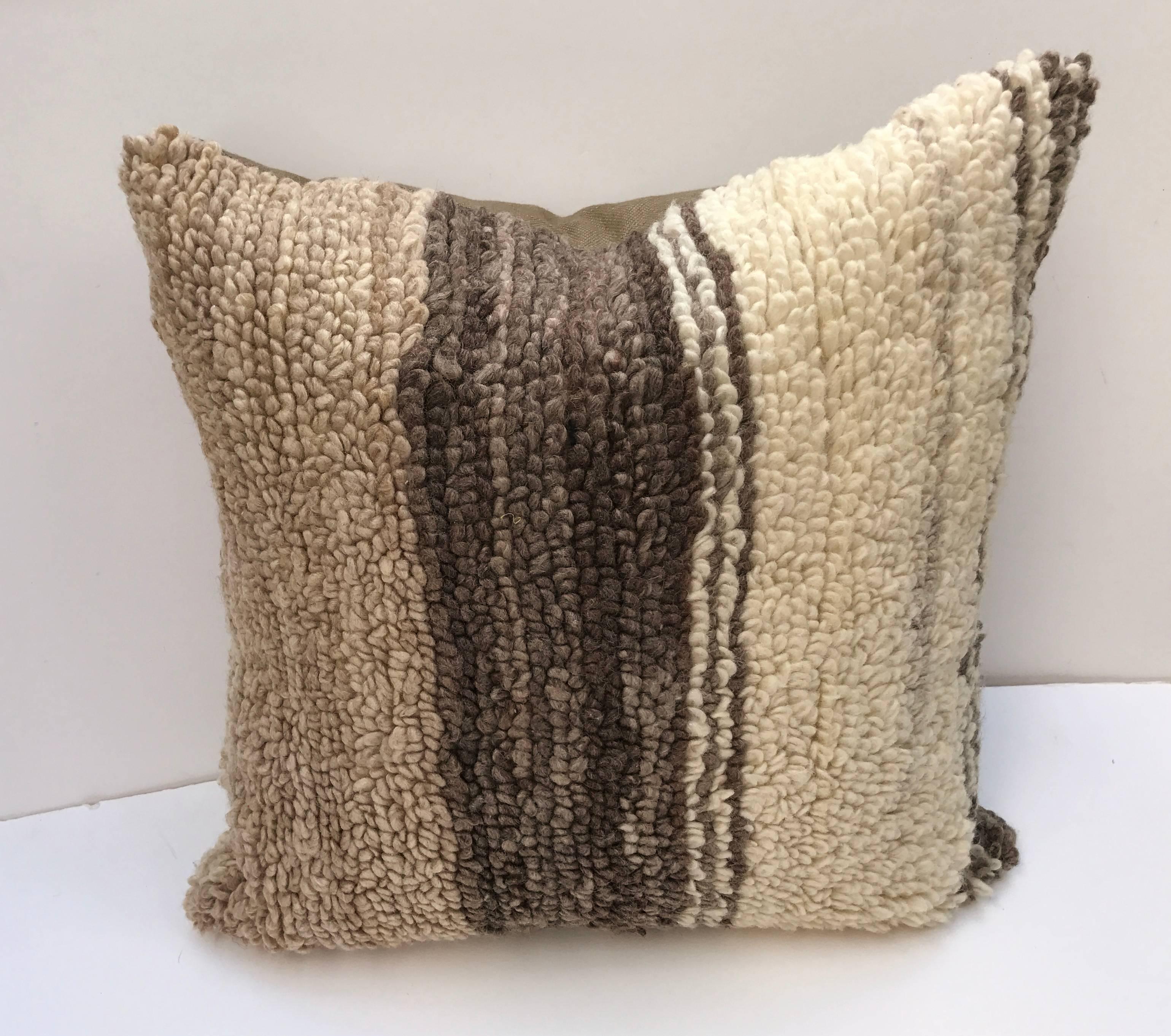 Custom pillow cut from a vintage hand loomed wool Moroccan Beni Ouarain Berber rug from the Atlas Mountains. Wool is soft and lustrous with all natural color. Pillow is backed in linen, filled with an insert of 50/50 down and feathers and hand-sewn
