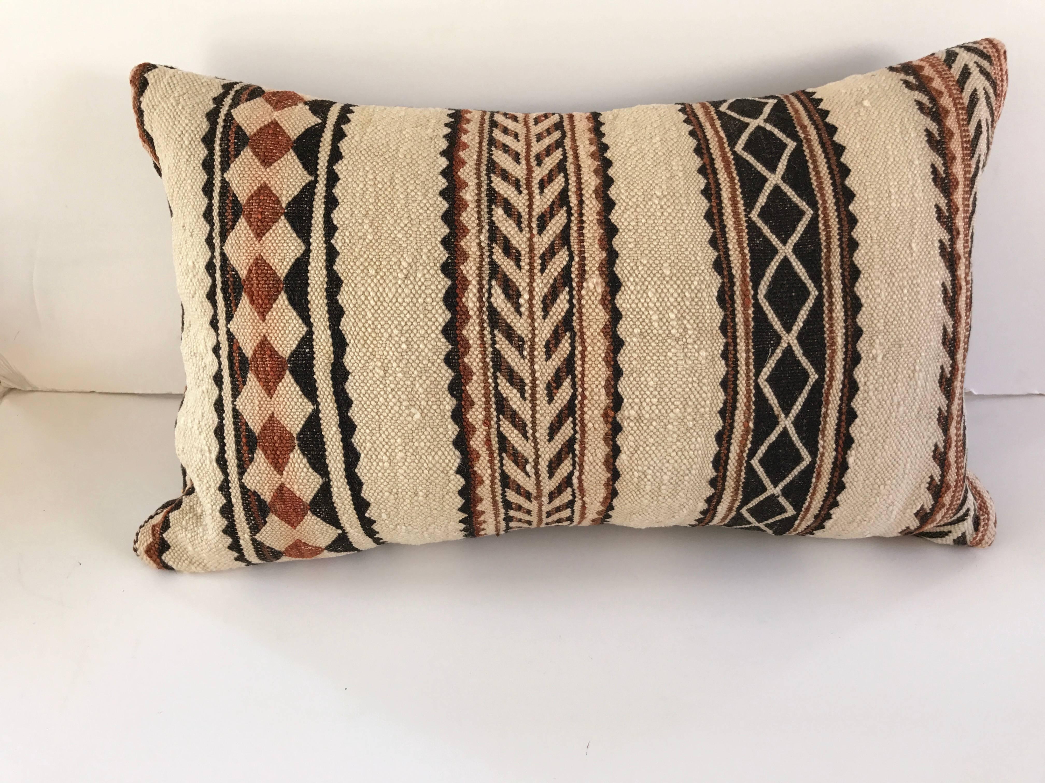 Custom pillow cut from a hand loomed wool vintage Moroccan Berber rug from the Atlas Mountains. Wool is soft and lustrous with natural color. Pillow is backed in a linen blend, filled with an insert of 100% down and hand-sewn closed. All custom
