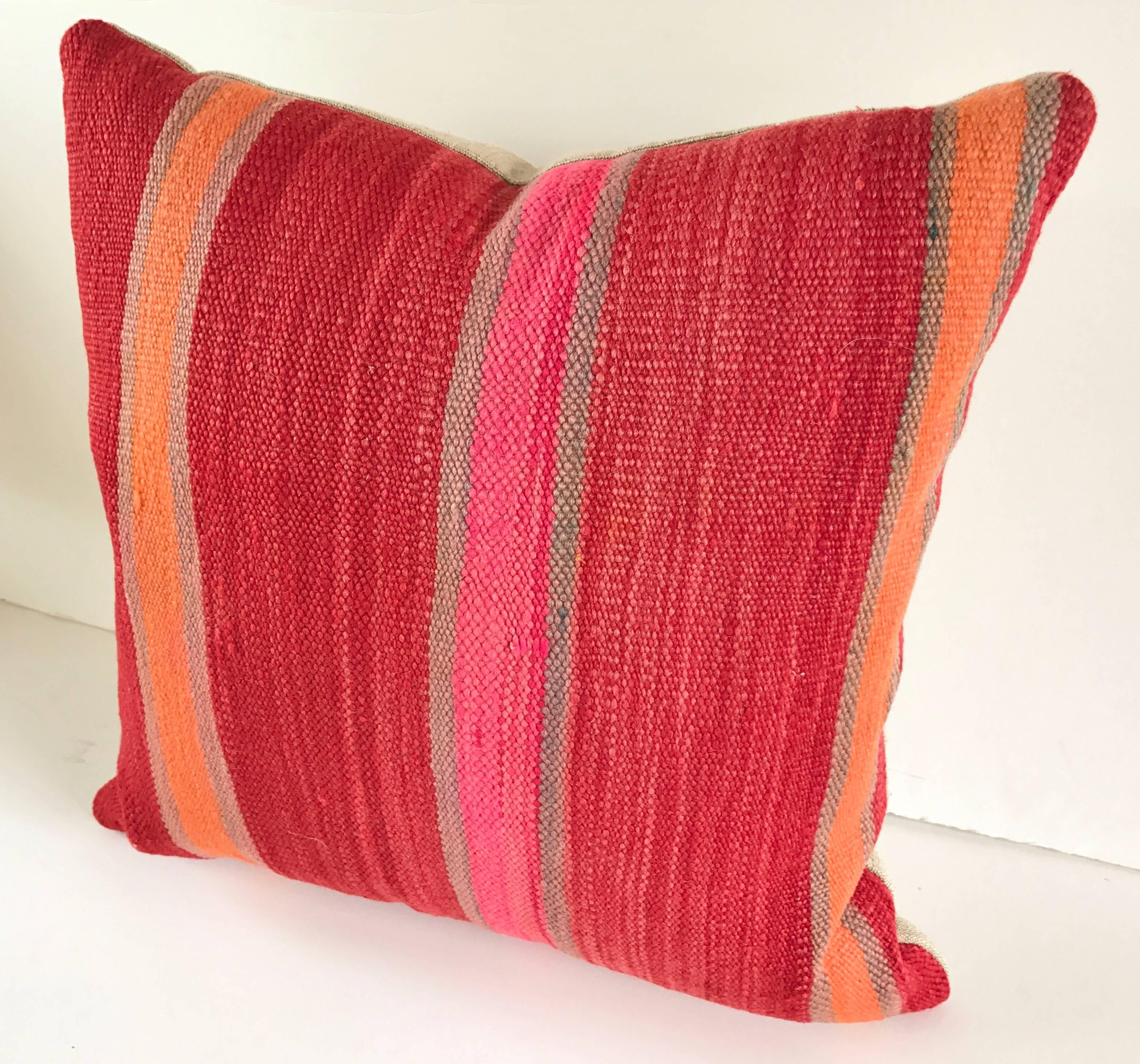 Custom pillow cut from a vintage Moroccan hand loomed wool Berber rug from the Atlas Mountains. Solo is soft and lustrous with good color. Pillow is backed in linen, filled with an insert of 50/50 down and feathers and hand-sewn closed. All custom