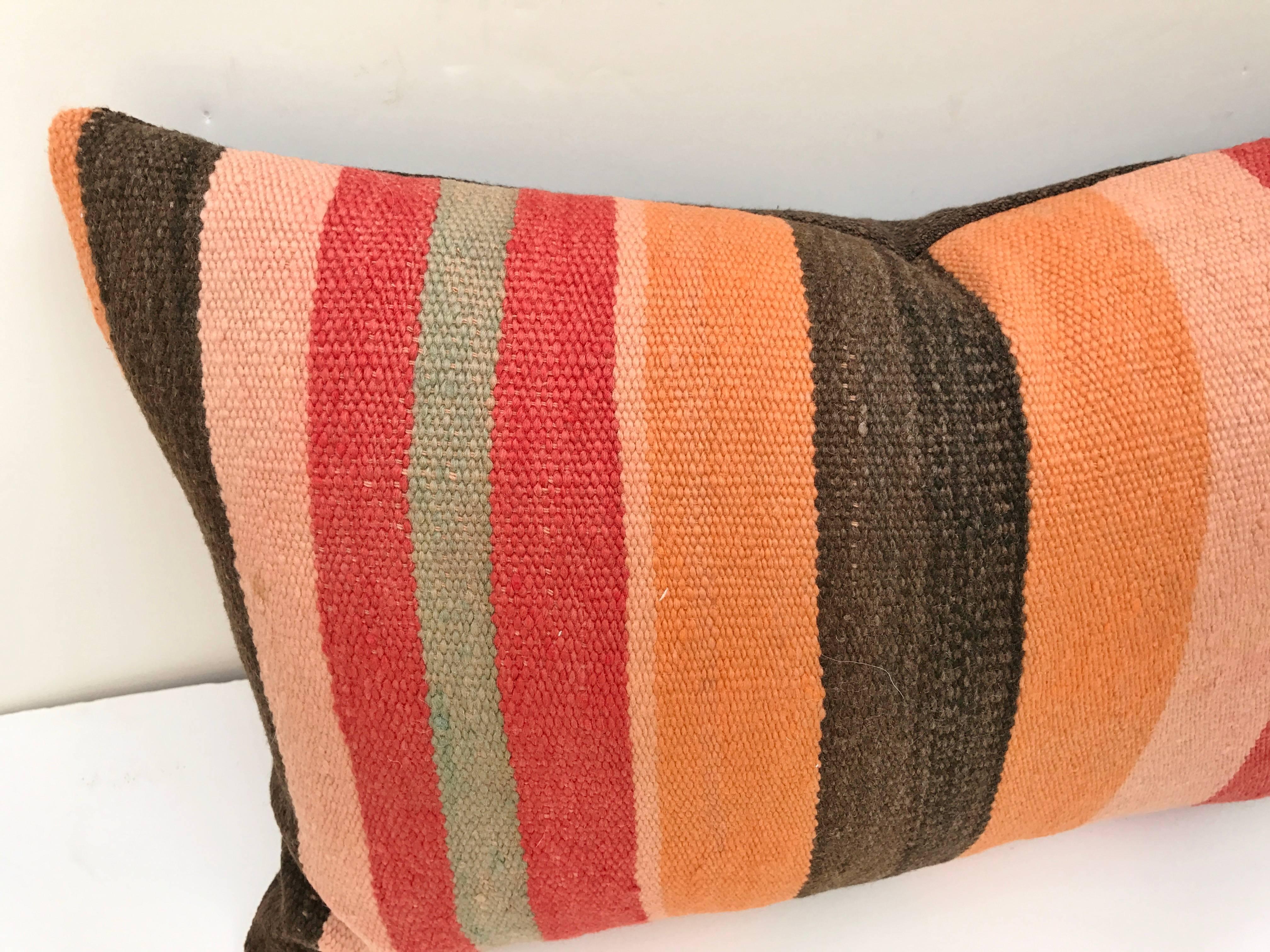 Custom pillow cut from a hand-loomed wool Moroccan Berber rug from the Atlas Mountains. Wool is soft and lustrous with natural dyes, Pillow is backed in a dark brown linen blend, filled with an insert of 50/50 down and feathers and hand-sewn closed.