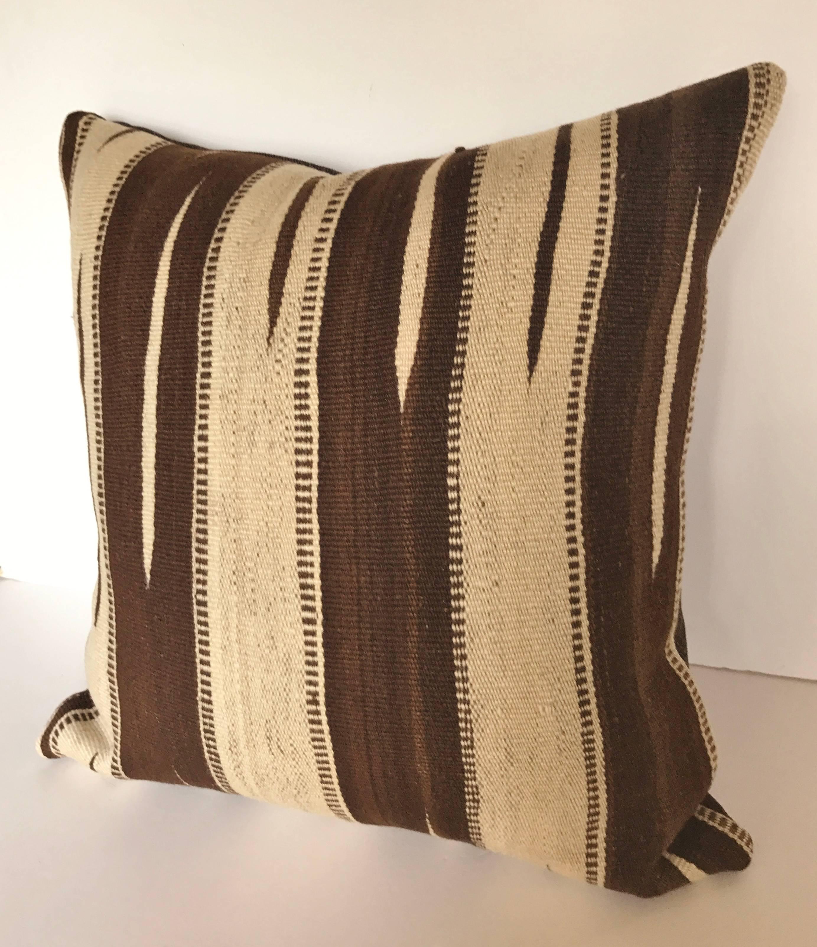 Custom pillow cut from a vintage hand loomed wool Moroccan Ourika Kilim from the Upper Atlas Mountains. Wool is soft and lustrous with natural colors and designs that were exclusively woven in the Ourika Valley. Pillow is backed in a linen blend,