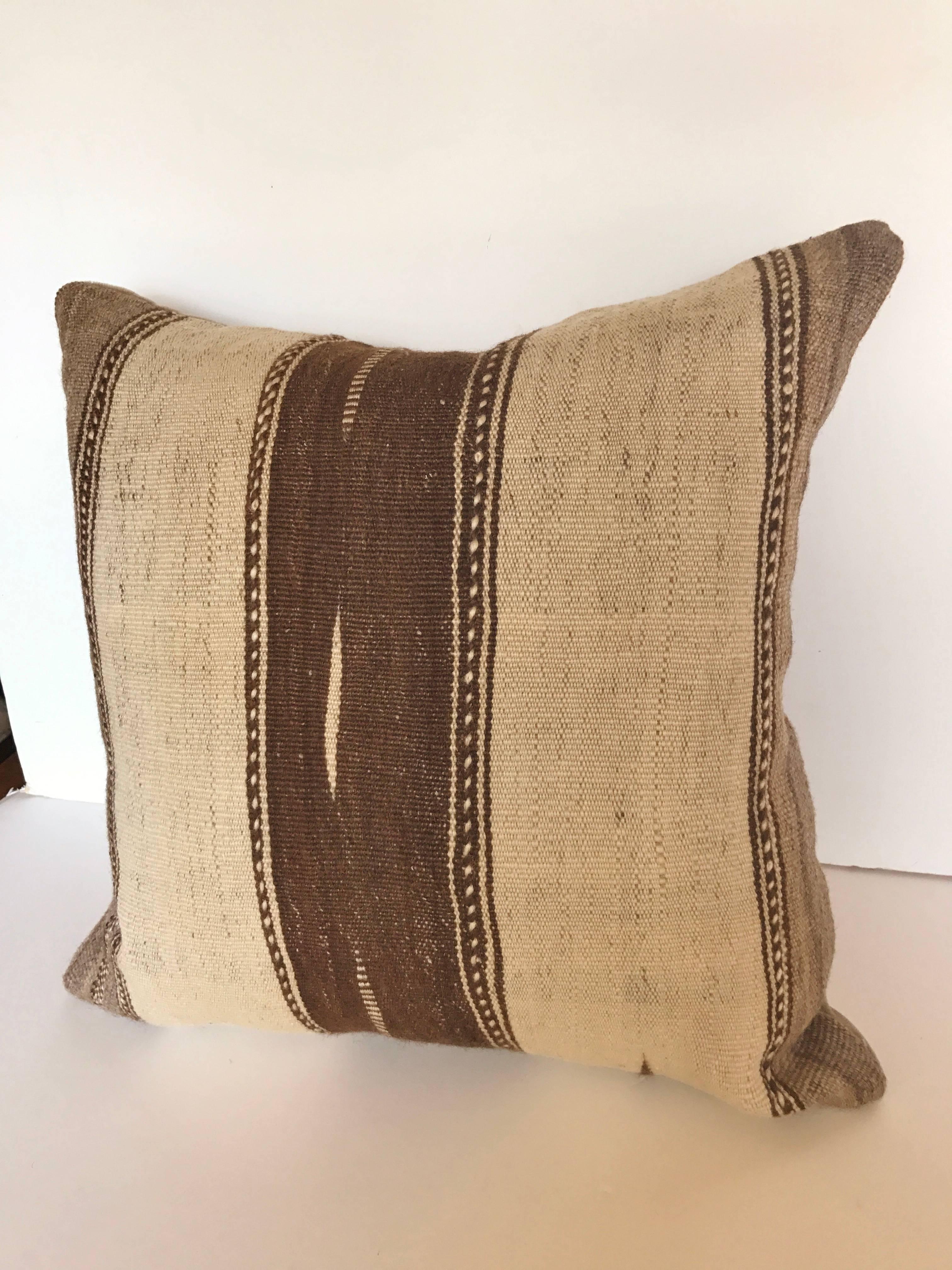 Custom pillow cut from a vintage hand loomed wool Moroccan Ourika Kilim from the High Atlas Mountains. Wool is soft and lustrous with all natural colors. Designs are exclusive to the Ourika Valley. Pillow is backed with mohair, filled with an insert