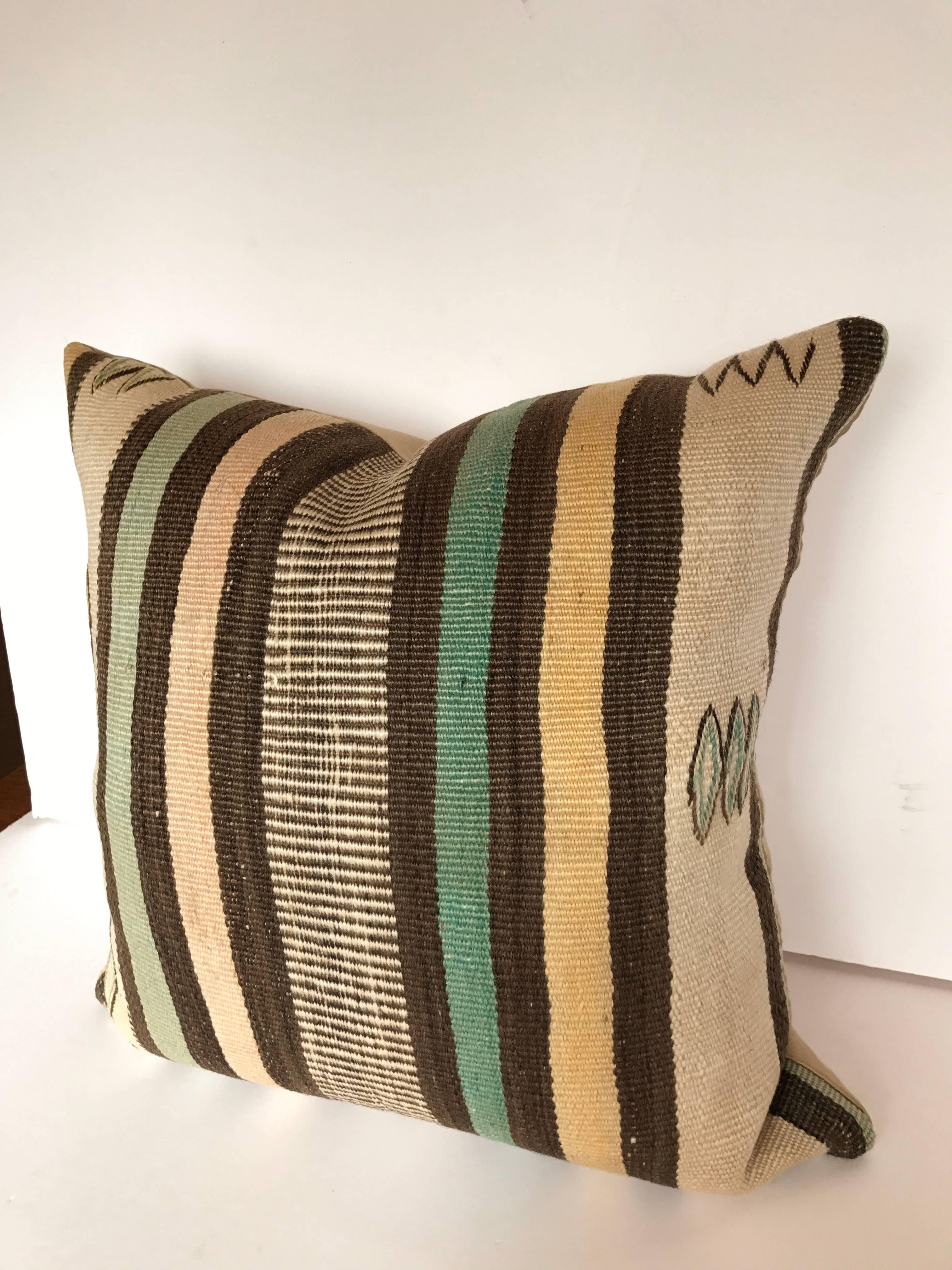 Custom pillow cut from a vintage hand-loomed wool Moroccan Rug from the Atlas Mountains. Wool is soft with good color. Pillow is backed in linen/wool blend, filled with an insert of 50/50 down and feathers and hand sewn closed. 