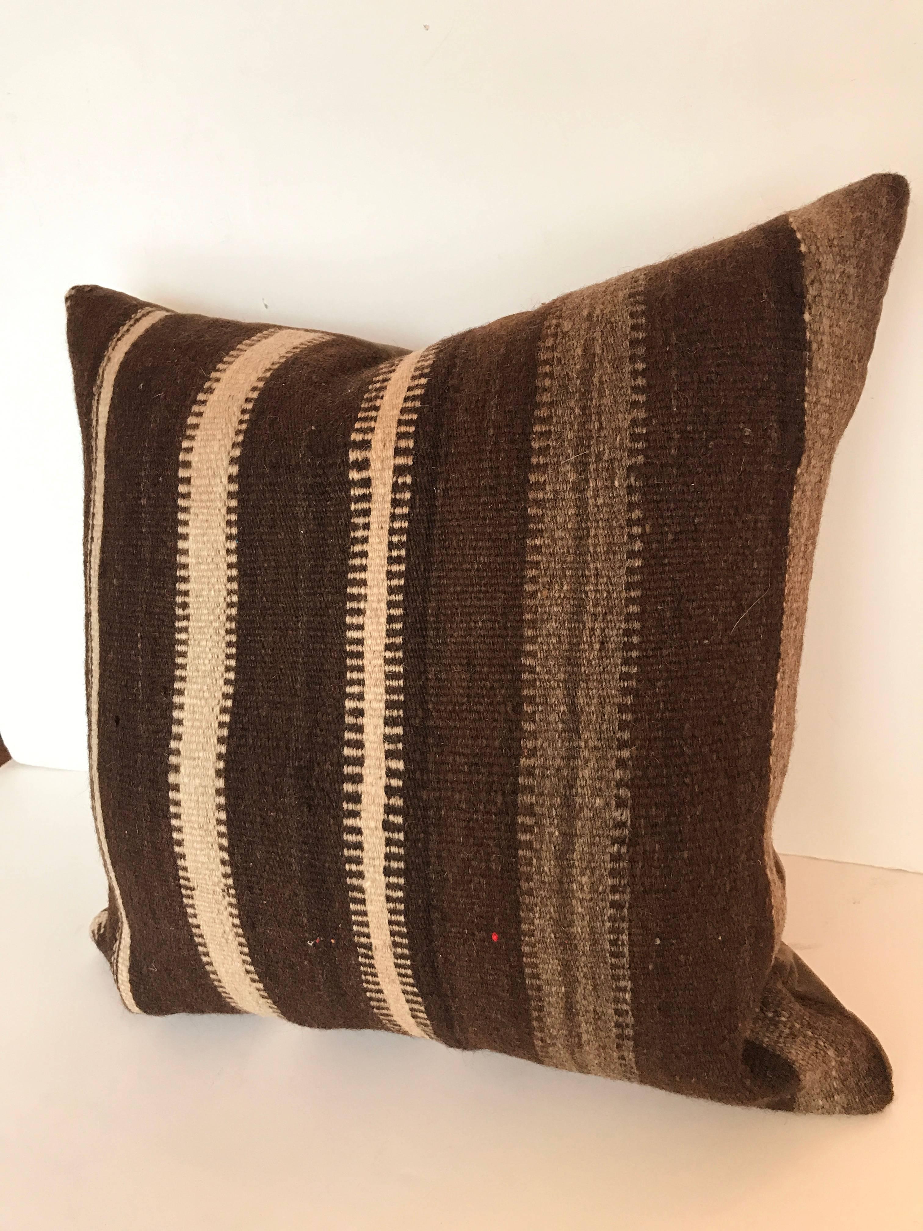 Custom pillow cut from a hand loomed wool Moroccan Ourika rug, high Atlas Mountains. Wool is soft and lustrous with all natural colors. Pillow is backed in velvet, filled with an insert of 50/50 down and feathers and hand-sewn closed. 