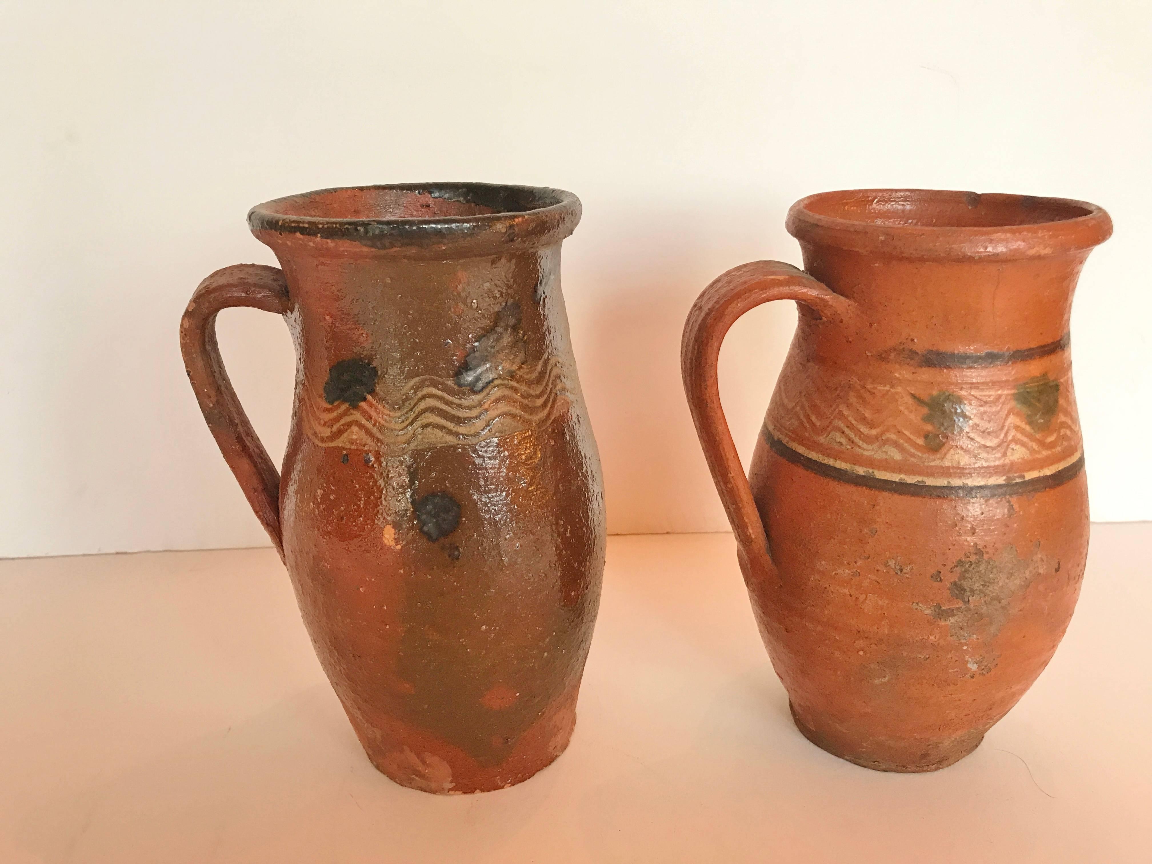 Vintage Transylvania red ware pottery pitchers,  splatter painted glaze.  Romanian terra-cotta, Folk Art.  Early to mid 1900's.  Measurments: One pitcher is 8.25