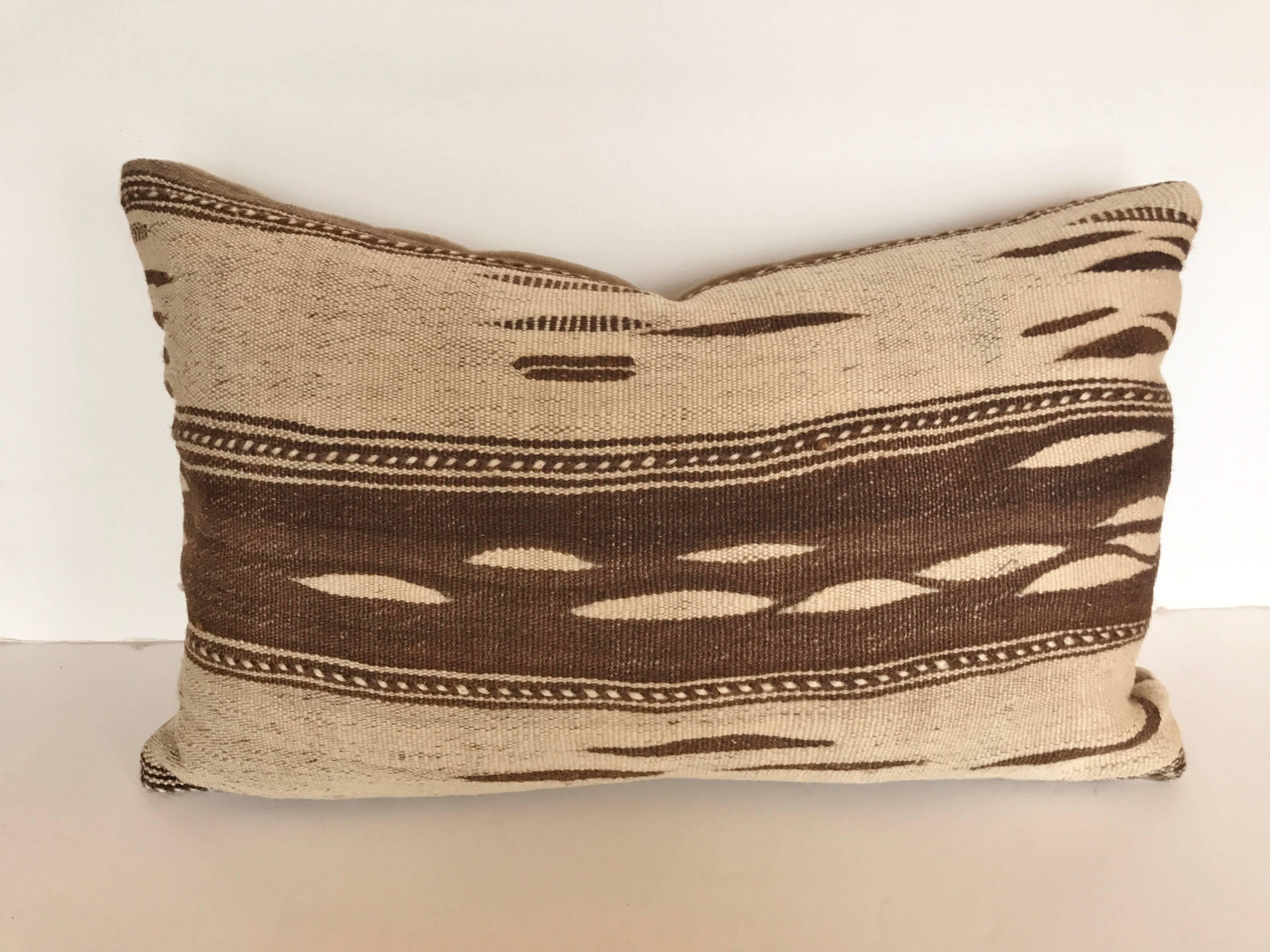 Custom pillow cut from a Moroccan hand loomed wool Ourika rug from the High Atlas Mountains.  Wool is soft and lustrous in natural colors.  Pillow is backed in mohair, filled with an insert of 100% down and hand sewn closed.  