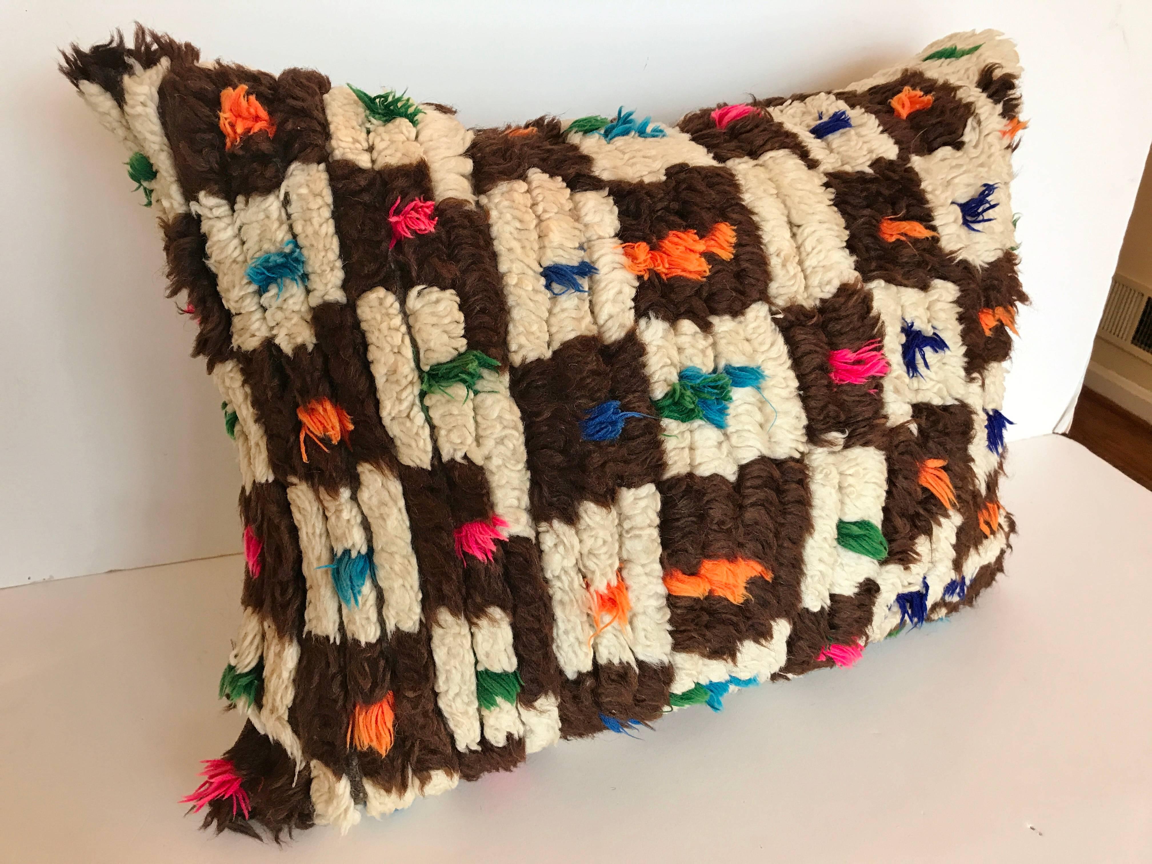 Custom pillow cut from a vintage hand loomed wool Moroccan rug from the Atlas Mountains.  Wool is soft and lustrous with good color.  Pillow is backed in a brown linen blend, filled with a 100% down insert and hand stitched closed.  Our pillows are